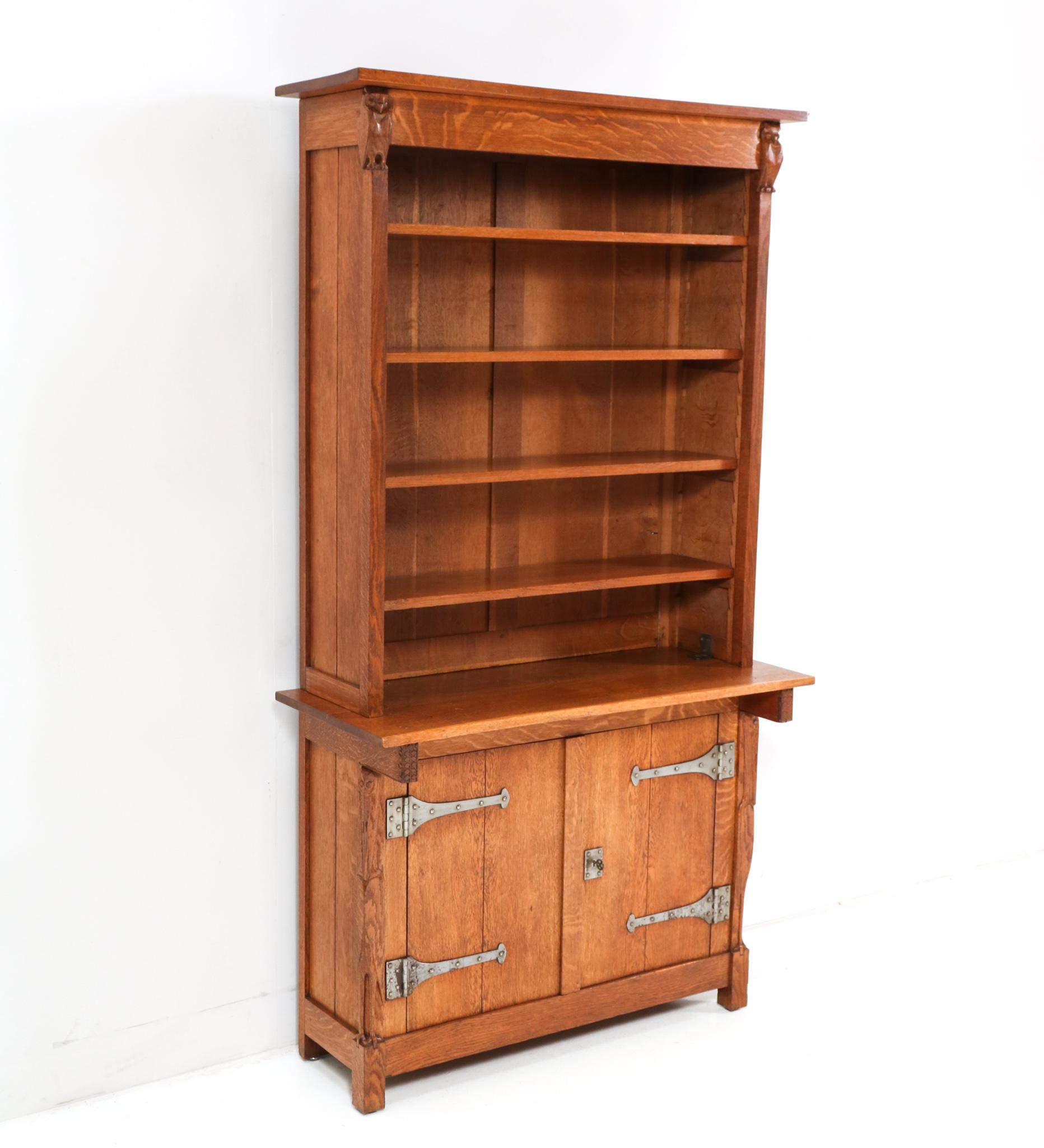 Magnificent and ultra rare Arts & Crafts two-piece bookcase.
Design by Alexander J. Kropholler.
Striking Dutch design from the 1890s.
Executed in solid oak and original wrought iron, this stunning and one of a kind 
 museum piece has two