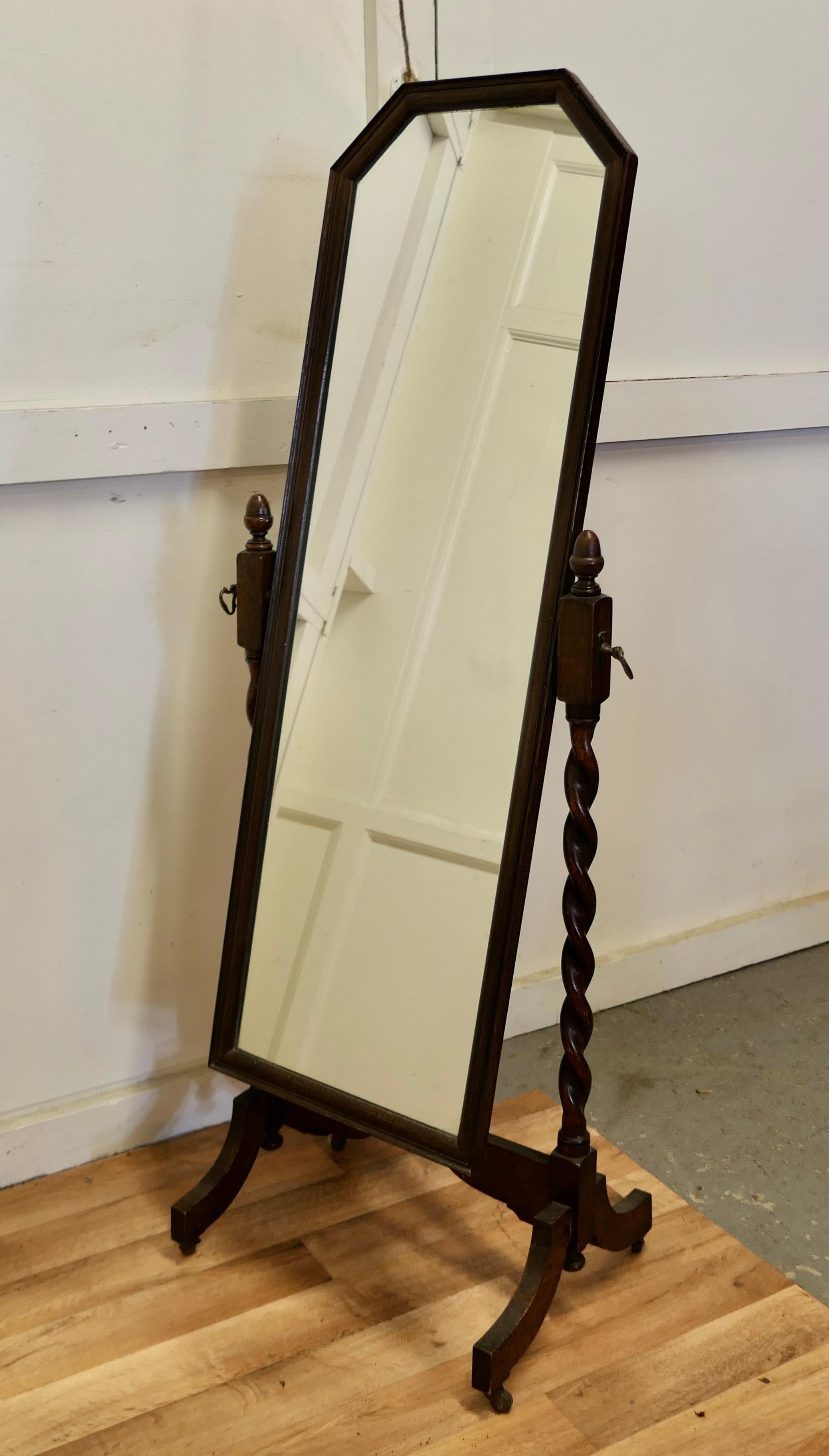 Oak barley twist cheval mirror 

This is a very attractive mirror, it is set on Barley-twist columns, the top the mirror has a chamfered shape, it sits firmly in its stand and swivels for maximum advantage
Both the stand and mirror are in very