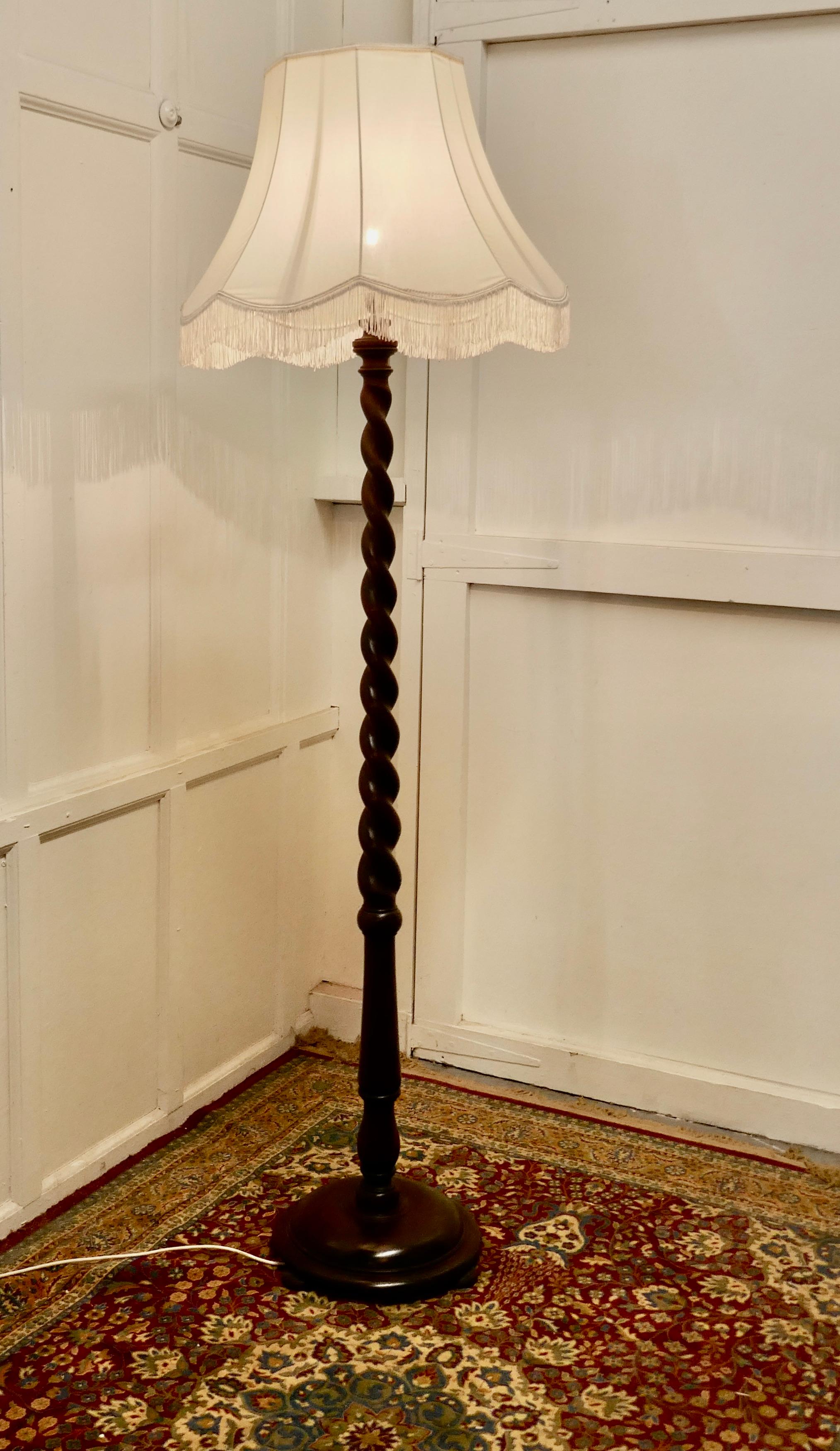 Oak barley twist floor standing lamp

A skilfully turned piece of 3” solid oak, this lamp stand on a turned wooden base, it is in good condition, the shade is not new but is included if desired 
The lamp is 63” high to the bayonet and the base is