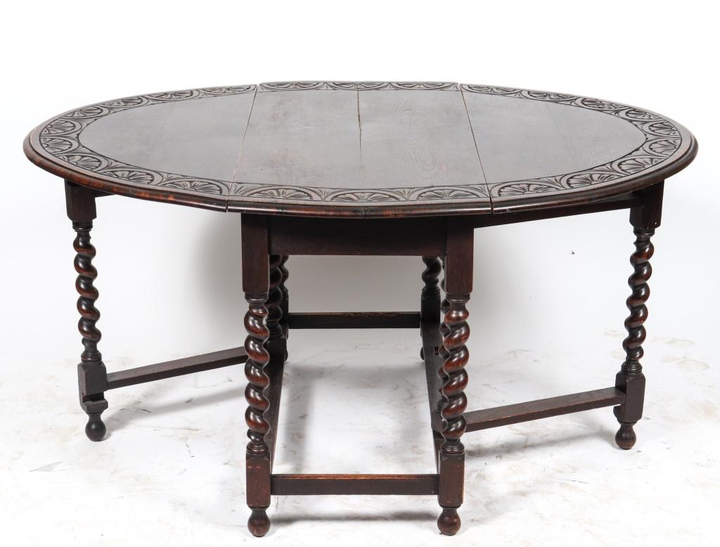 Oak barleytwist gateleg table, 20th century, the profile gates with carved Tudor Rose details, on spiral twist end legs connected by stretchers. 28.75