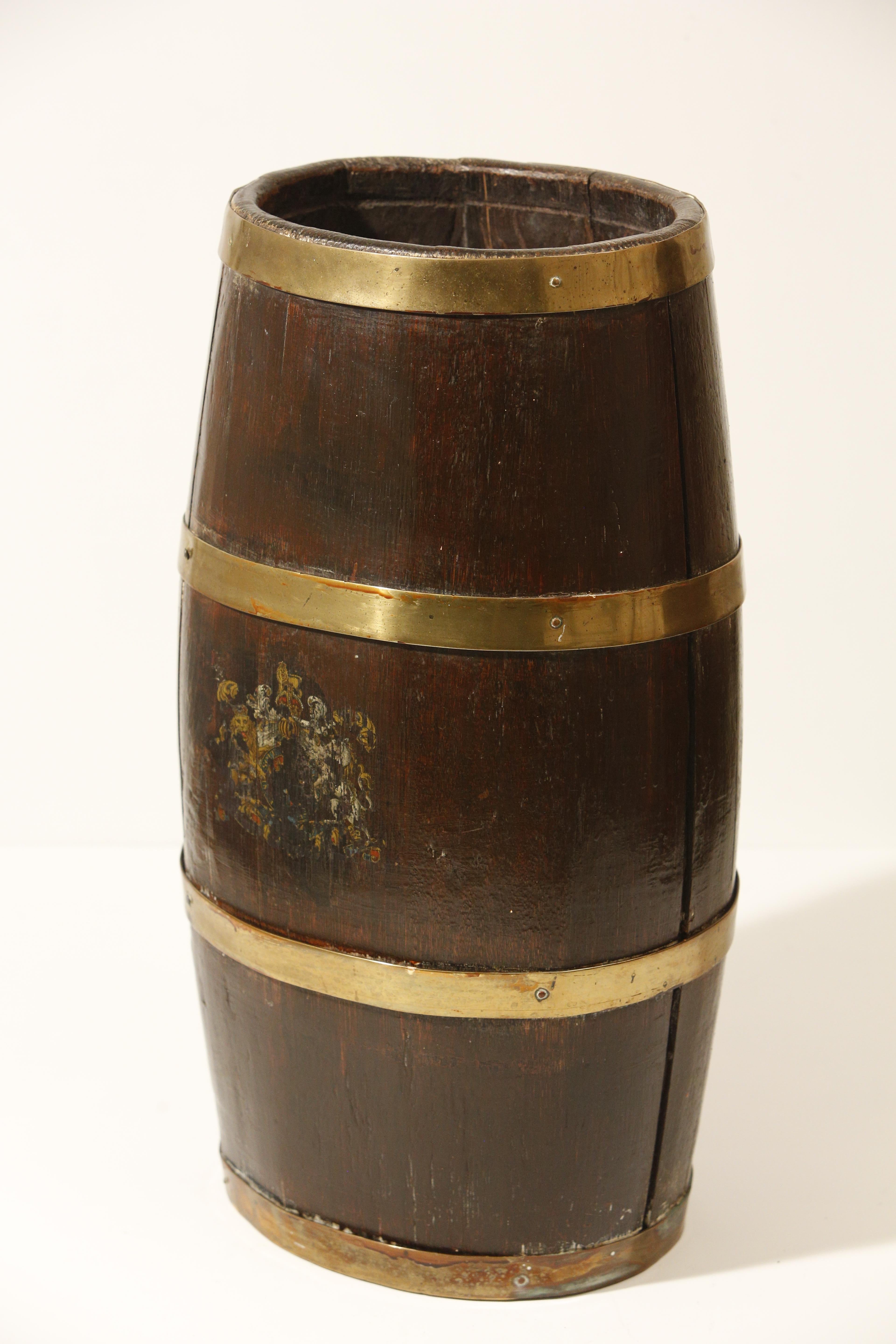 Charming 19th century brass bound coopered oak umbrella stick stand with lovely old wax patina.

Created in England this barrel features a sturdy oak body made vertical slats contrasted by the golden tones of the horizontal brass braces that