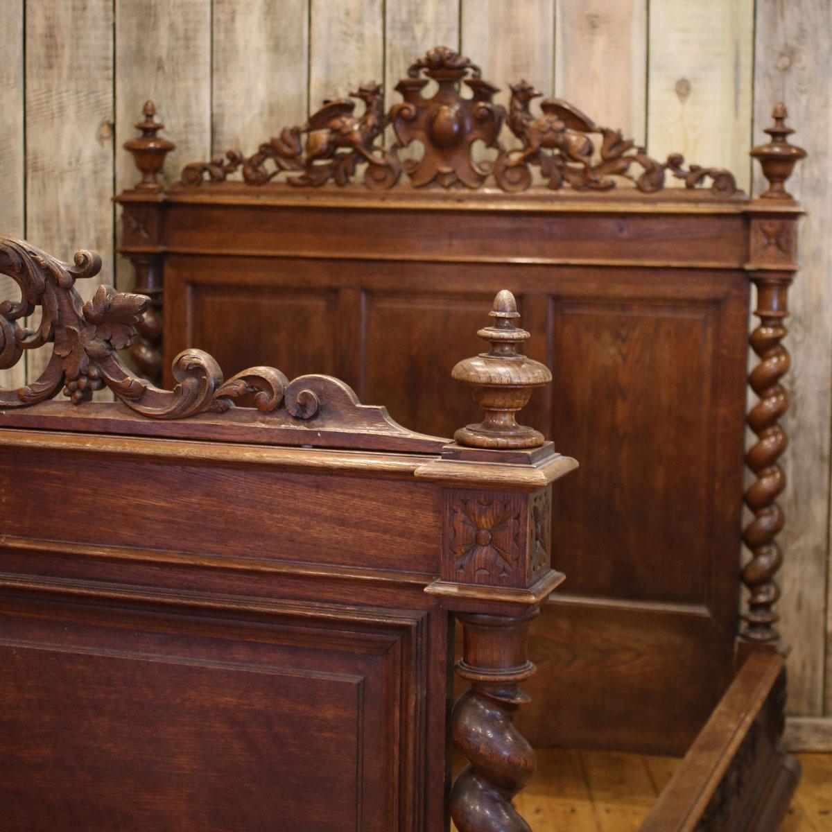 This bed has yet to be fully restored. Oak bed with barley twist posts and heraldic pediments depicting finely carved griffins. 

This bed has original wooden side runners which take a 6'0 long base and mattress and either 4ft 6