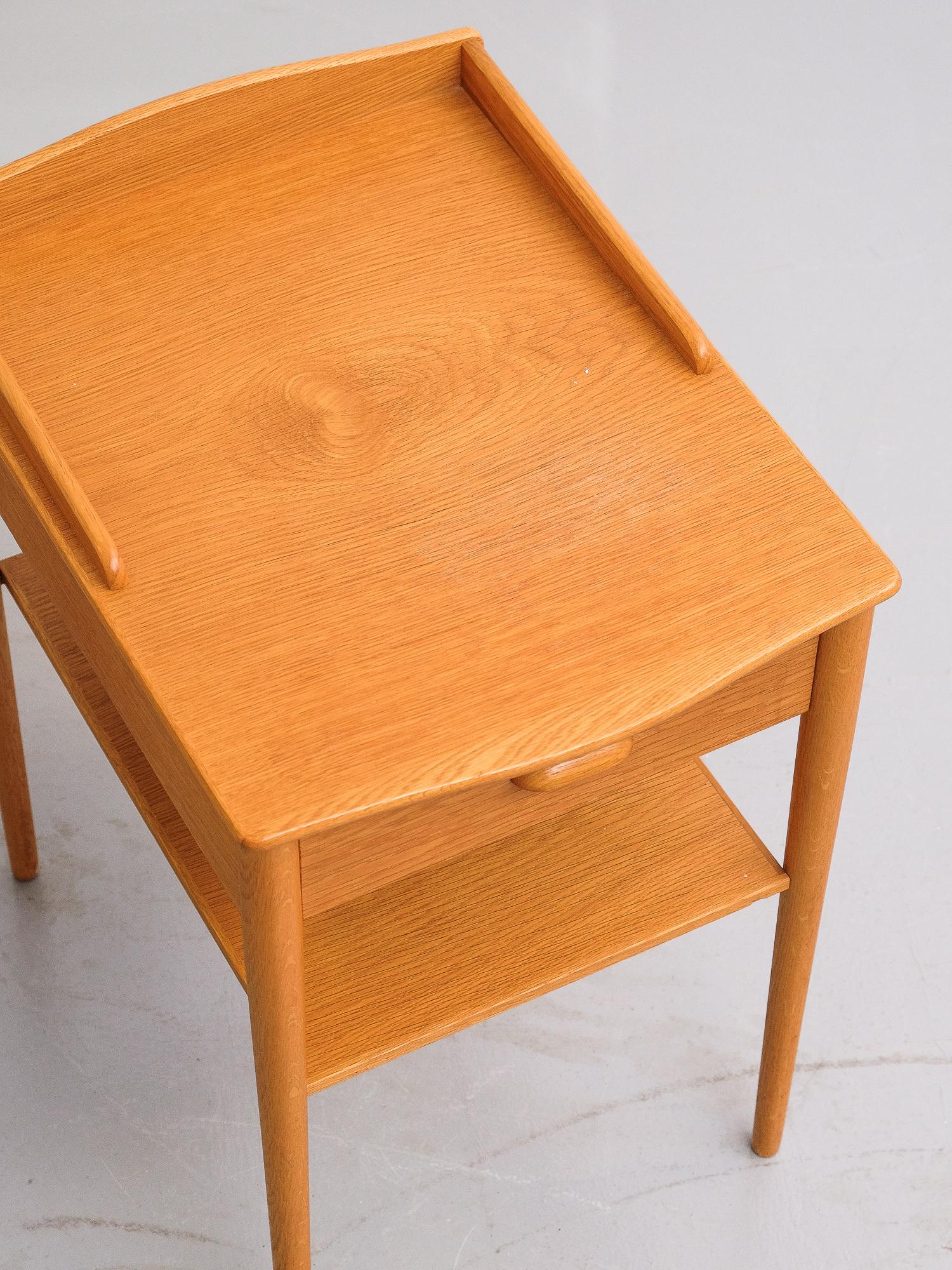 Pair of oak single drawer tables, made in Sweden by AB Erik Andersson & Co. They are very nice quality and could easily be used as bedsides, end tables as side or occasional tables. Very clean condition.