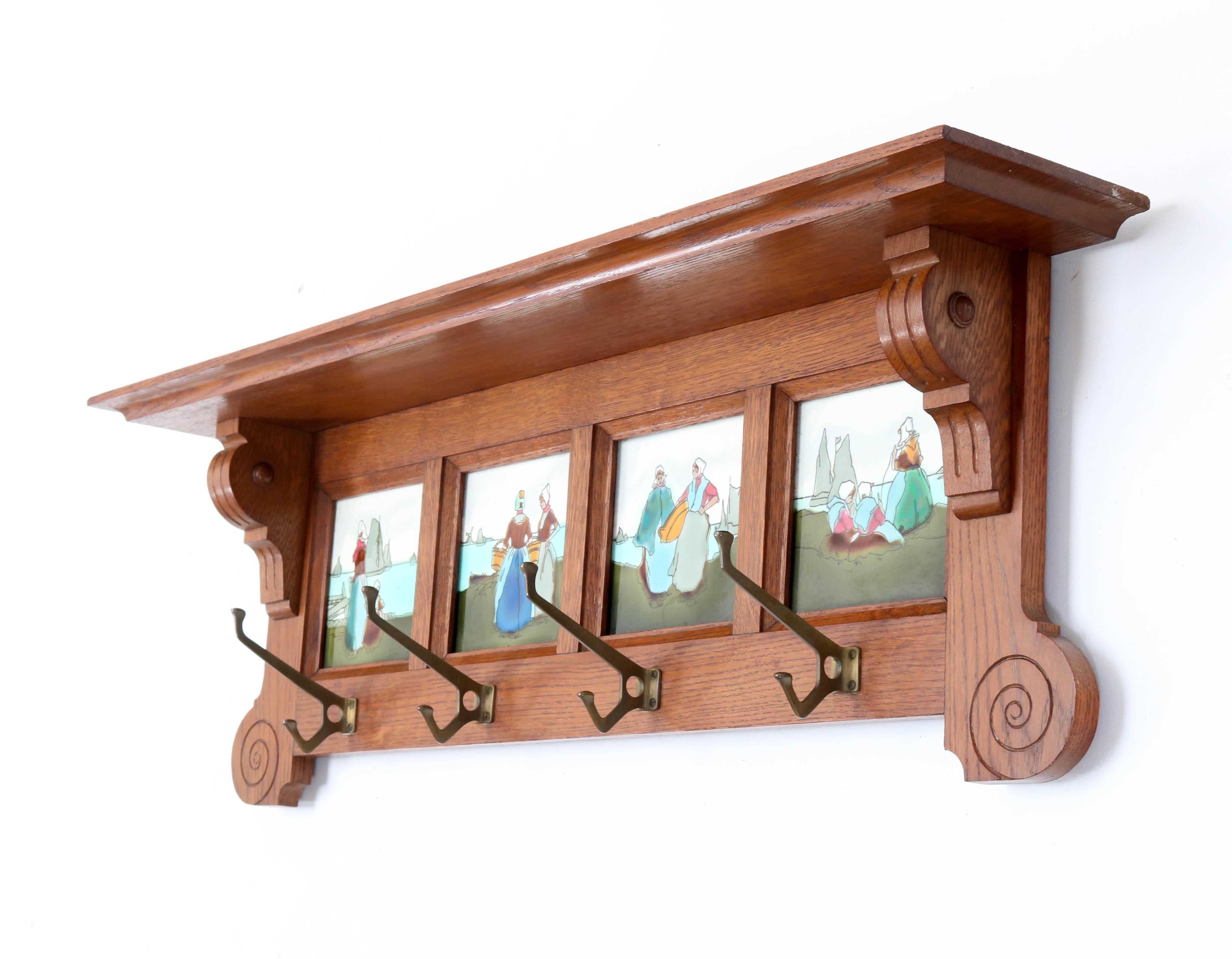Stunning and rare Art Nouveau wall coat rack.
Striking Belgium design from the 1900s.
Solid oak with four original ceramic tiles.
In very good condition with a beautiful patina.