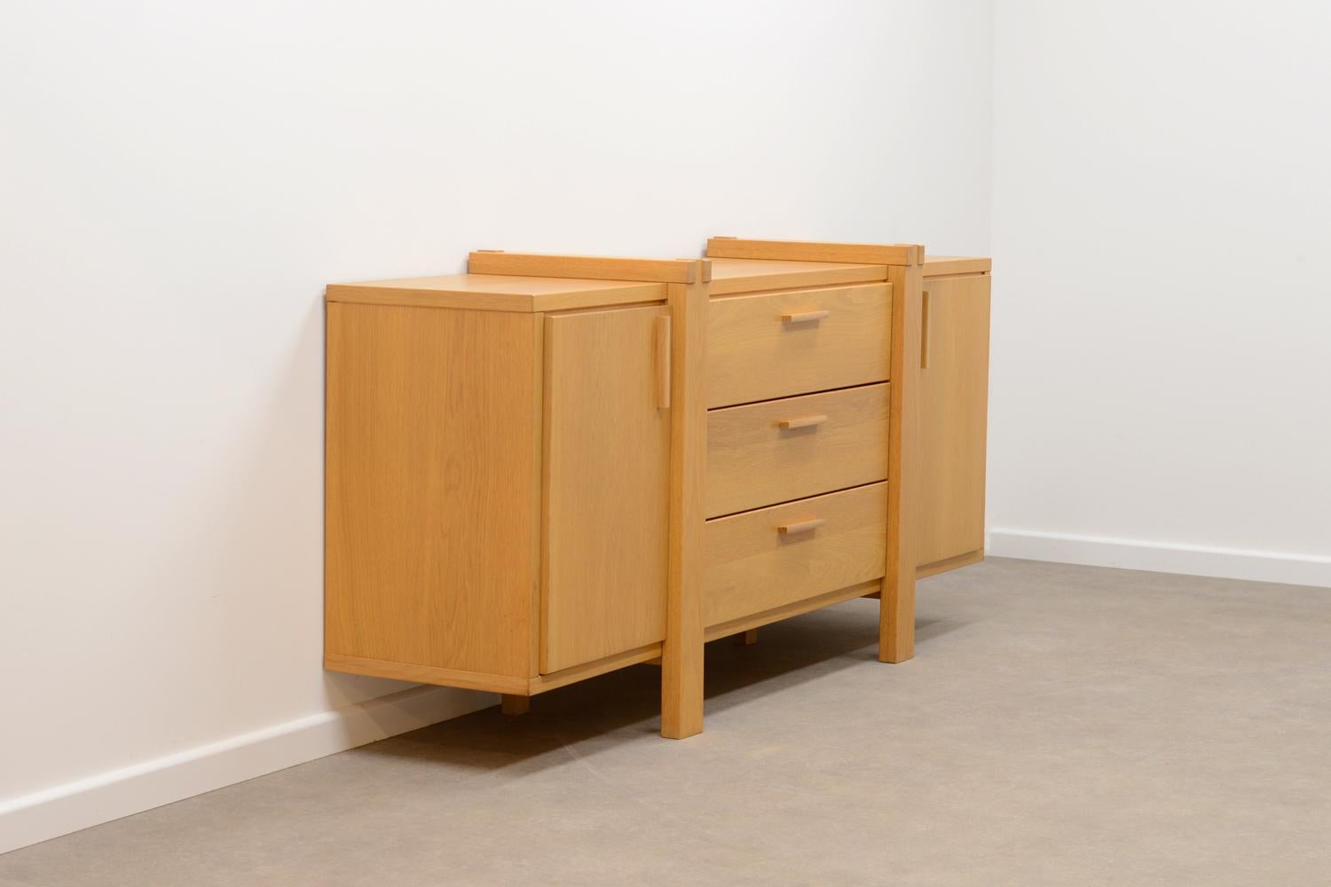 Belgium oak sideboard. Mostly made of solid oak. 3 drawers and 2 doors. Behind every door is a shelf. In very good vintag condition.