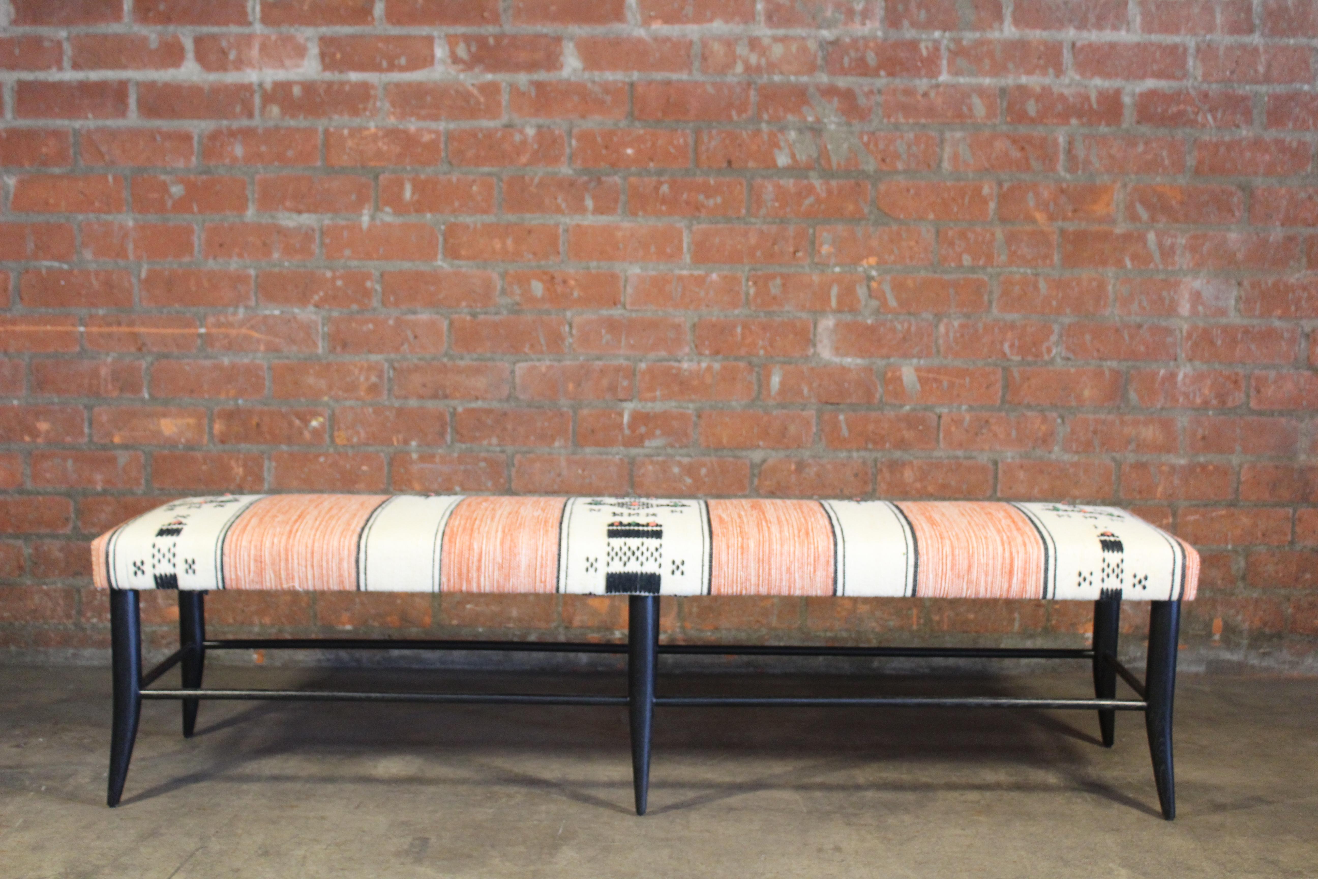 A solid oak handcrafted bench in dark cerused finish- handmade here in Los Angeles. Upholstered in a vintage orange and off-white Moroccan wool textile from the 1970s. In overall excellent condition.