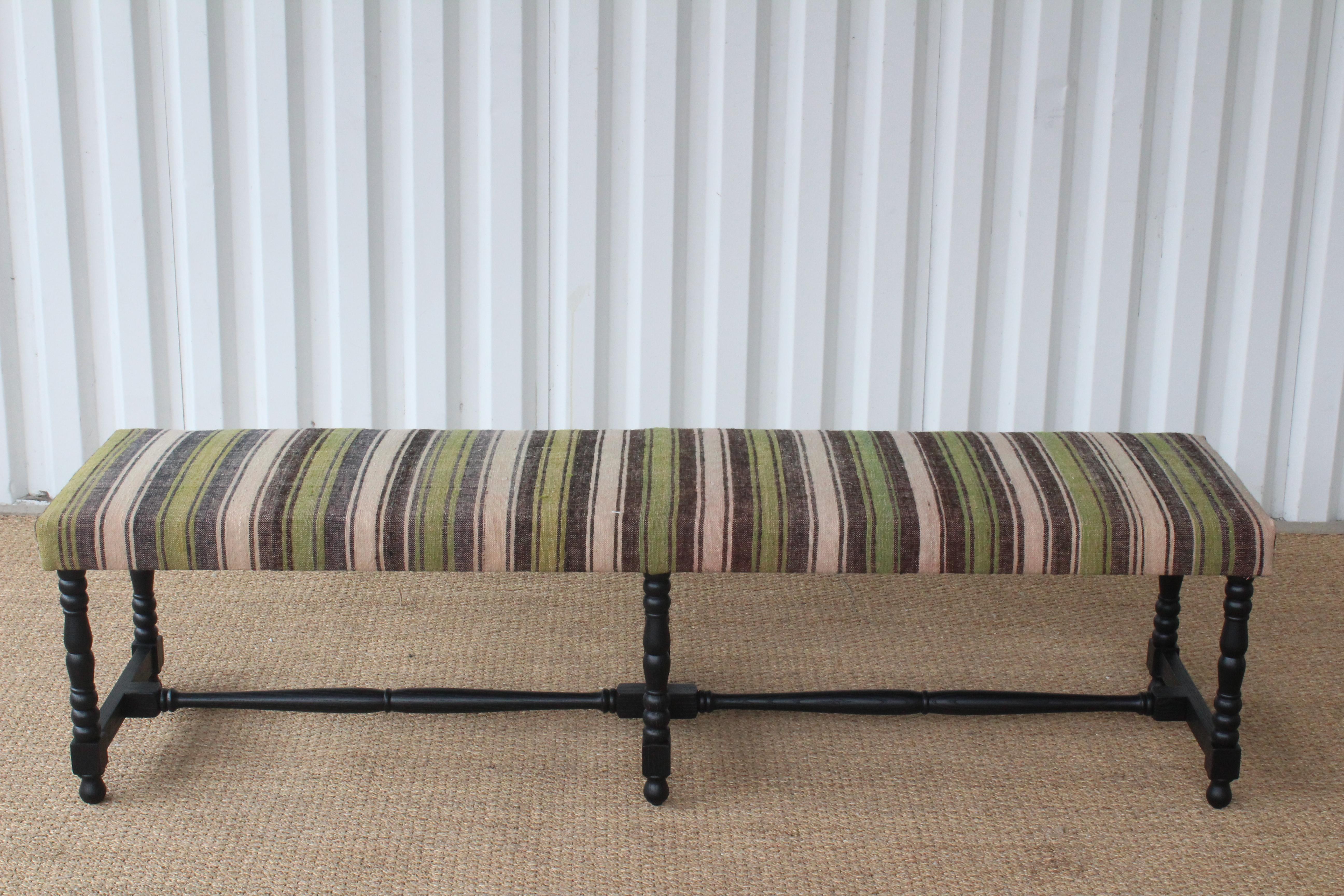 Oak bench upholstered in a vintage Turkish striped wool kilim. The oak base on this bench is custom made finished in satin black. The upholstery is vintage from the 1960s. In overall excellent condition, Turkish kilim upholstery may show minor signs