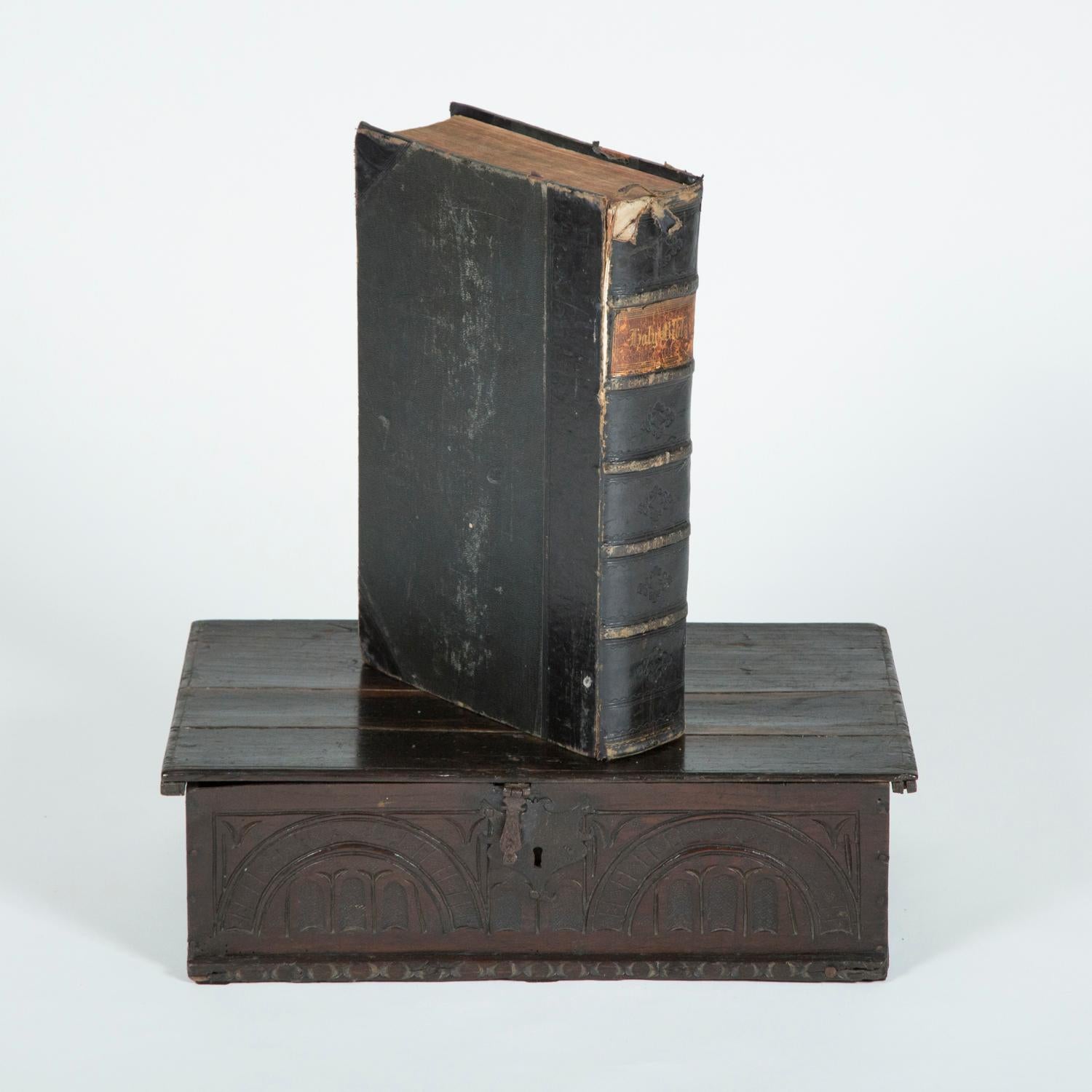 An oak bible box, with a carved arcaded front, with iron clasp and hinges. Containing a family bible. 

The Holy Bible printed by M. Brown of Newcastle upon Tyne, dated MDCCXCI (1791). 

The interior of the bible has handwritten family history,