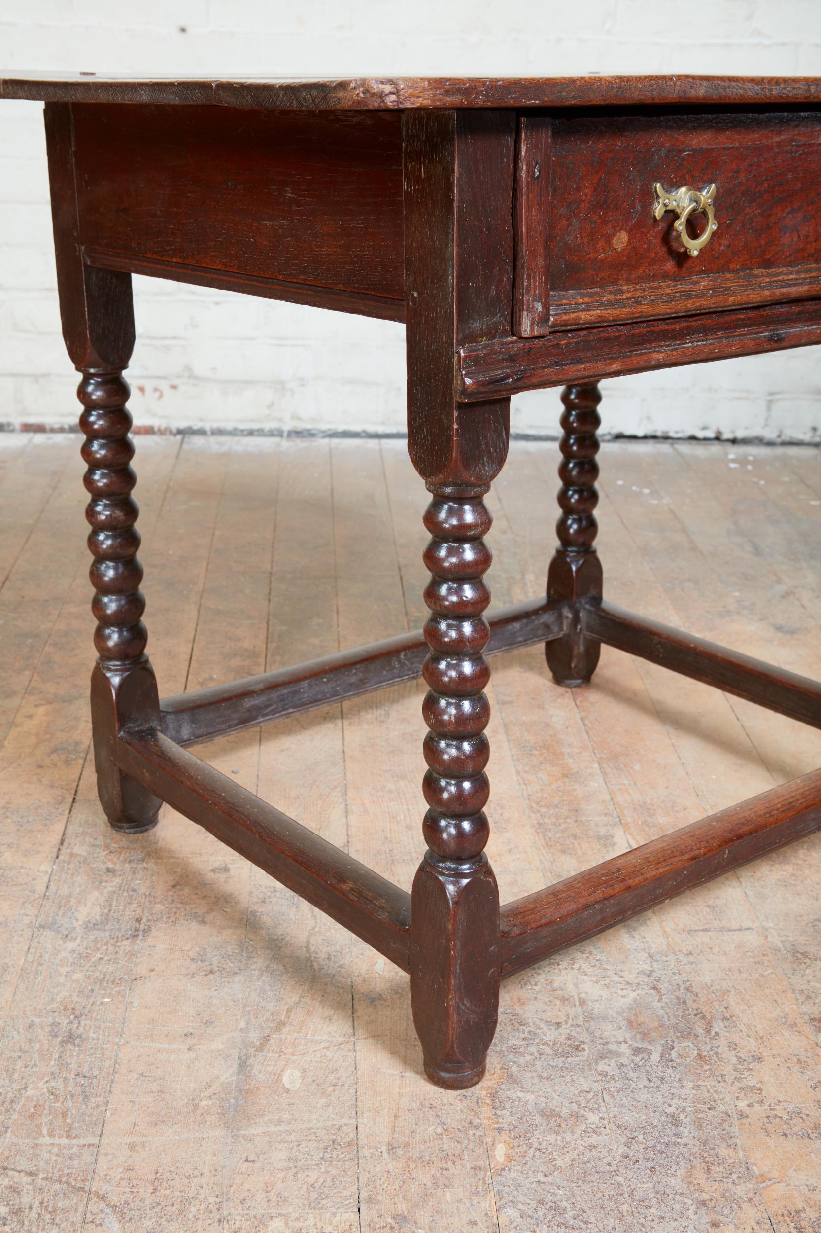 Good Charles II English oak table, the richly patinated three plank top over single drawer with applied block molded edges, standing on boldly turned legs joined by box stretchers, the whole with good patina and rich color.