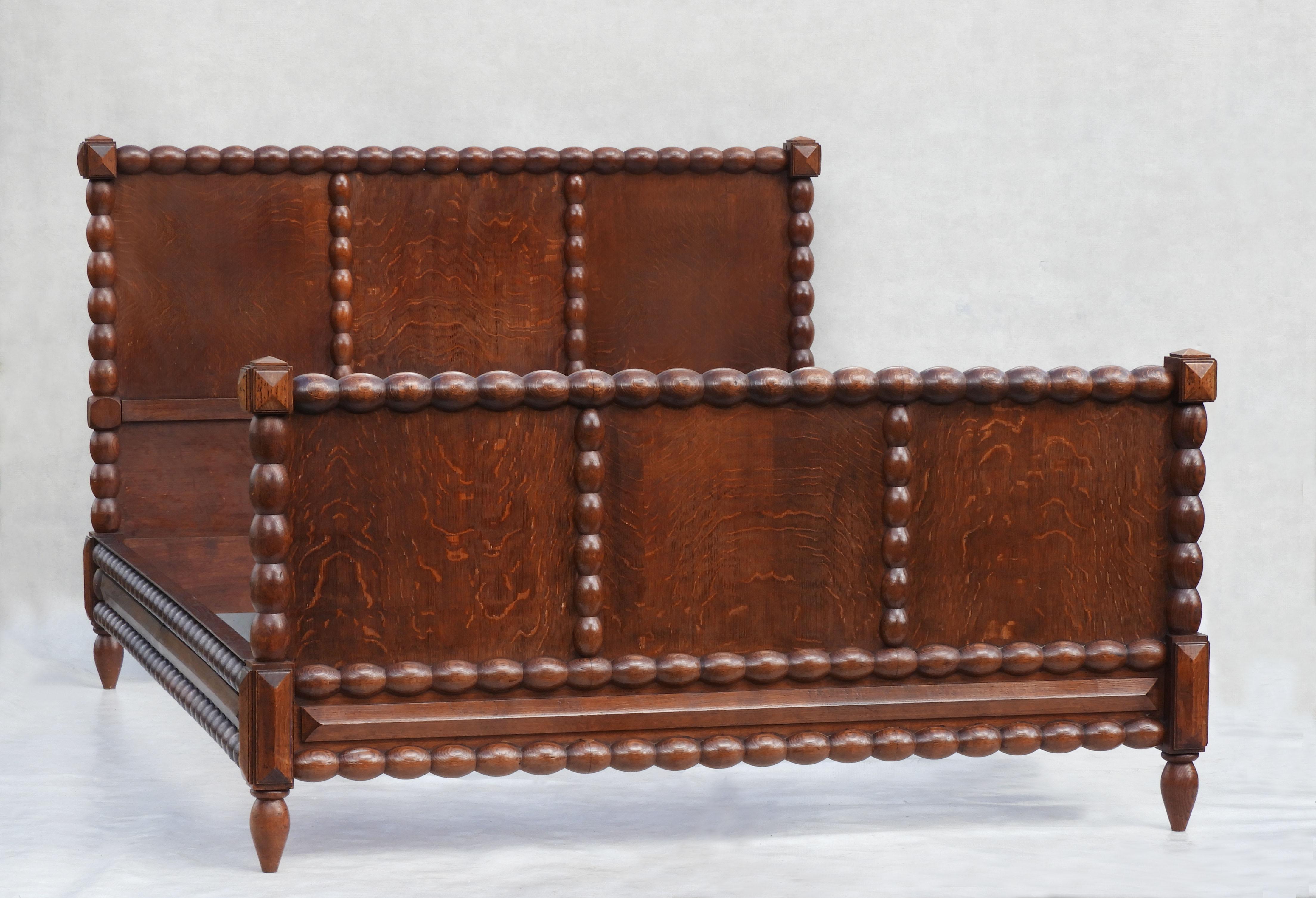 Charming French mid-century bobbin wood bed in the style of Charles Dudouyt C1940   Beautifully turned and carved bobbin wood detailing surrounding oak veneer pannelling.  This bed will accommodate a full-length UK king-size or a US Queen-size