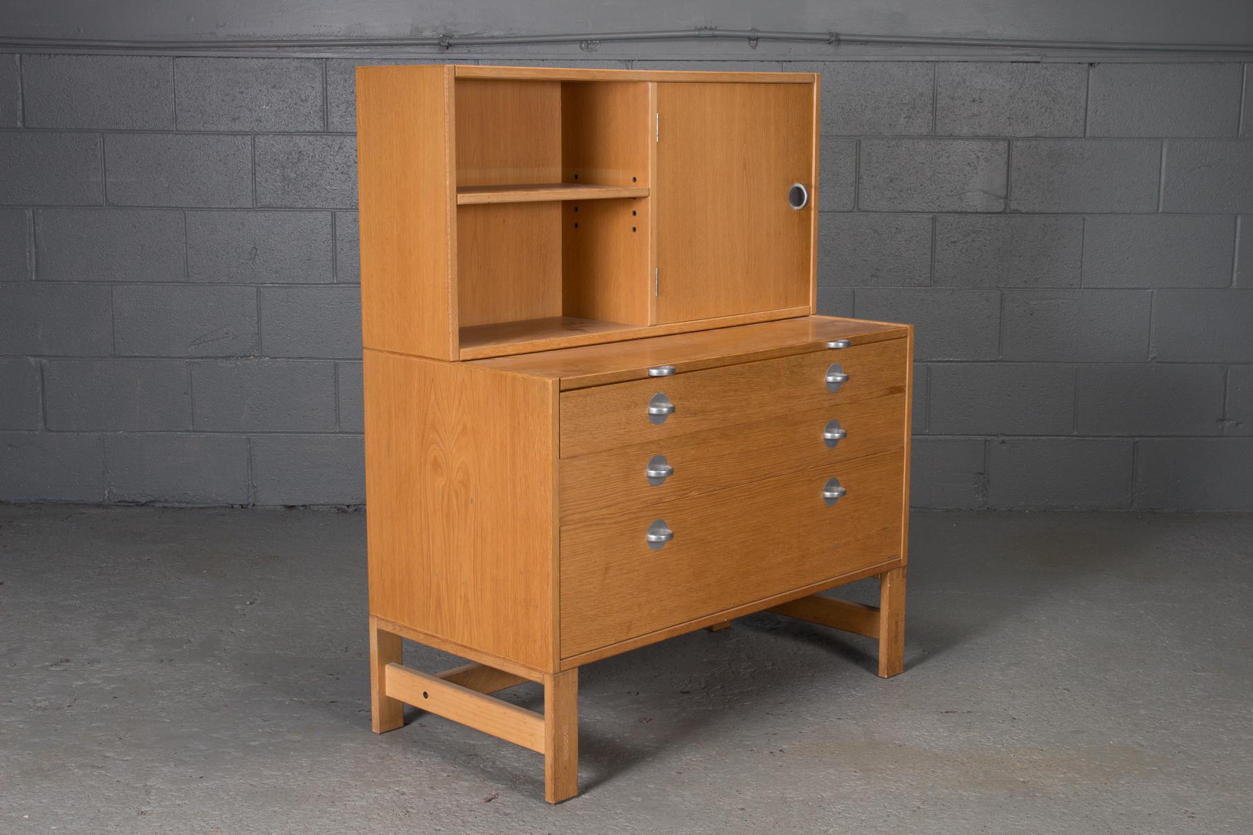 Oak bookcase unit and chest with stainless steel handles.