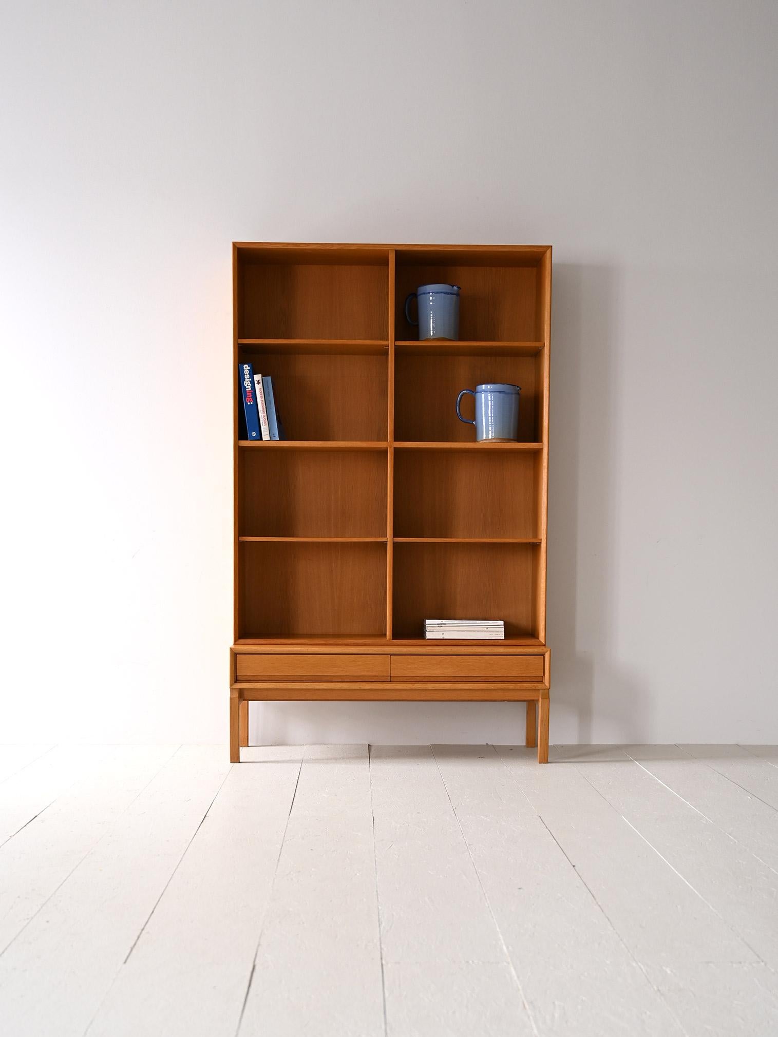 Scandinavian cabinet composed of two parts.

An original vintage furniture piece formed by a base with two drawers on which rests a structure formed by height-adjustable shelves.
This bookcase stands out for its regular lines and modern taste given