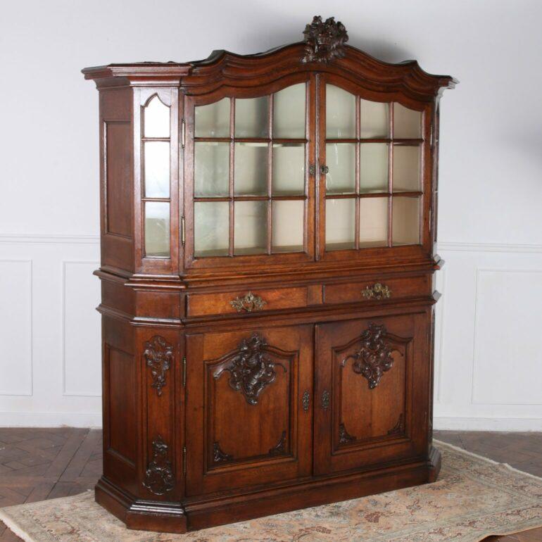 A Dutch, Mid-19th century oak buffet hutch with original gilt bronze hardware, glazed door panels in tact and a wonderful patina.