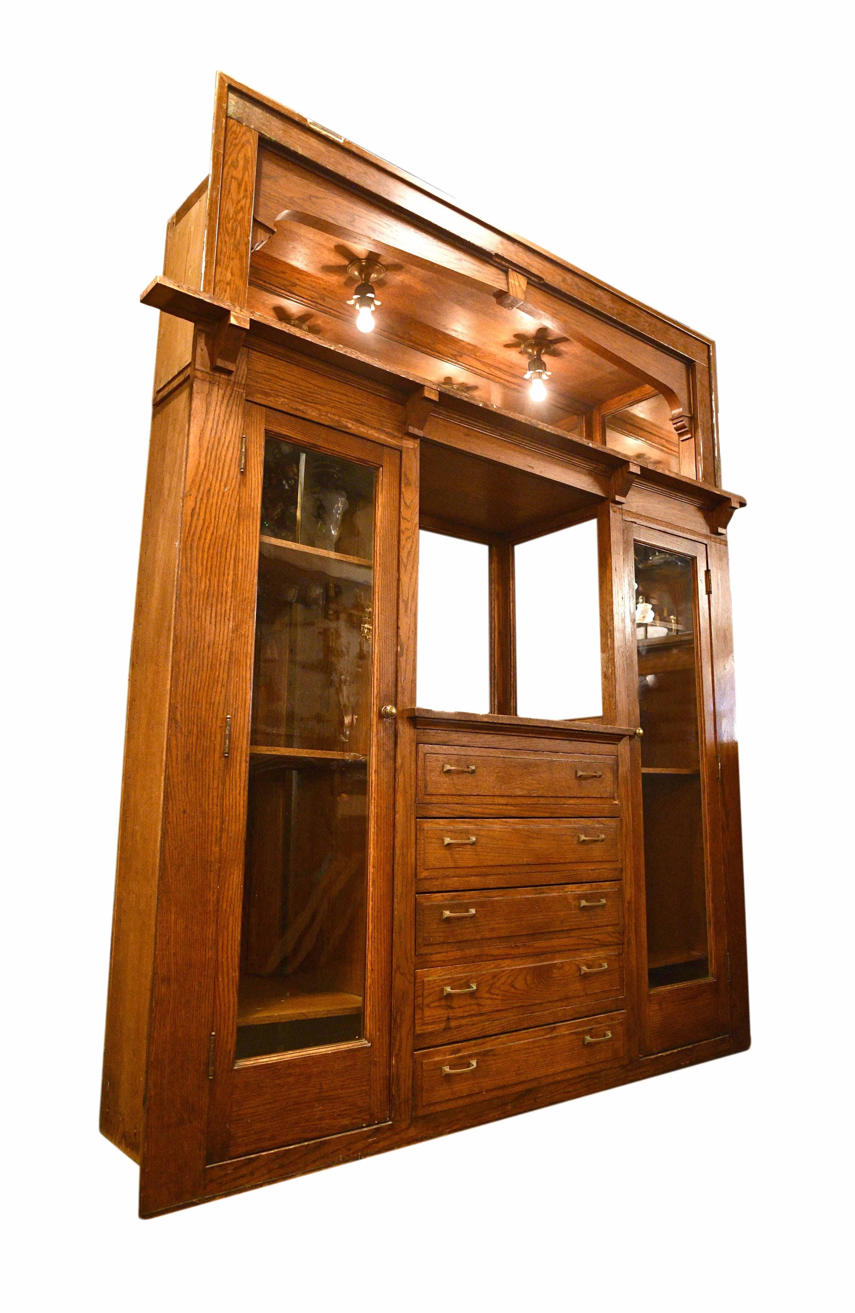 This finely crafted buffet is made of handsome oak and features 6 mirrors, two large cabinets, and 5 drawers, giving it ample storage space. Uniquely, two floral flushmount lights hang from the top of the buffet!