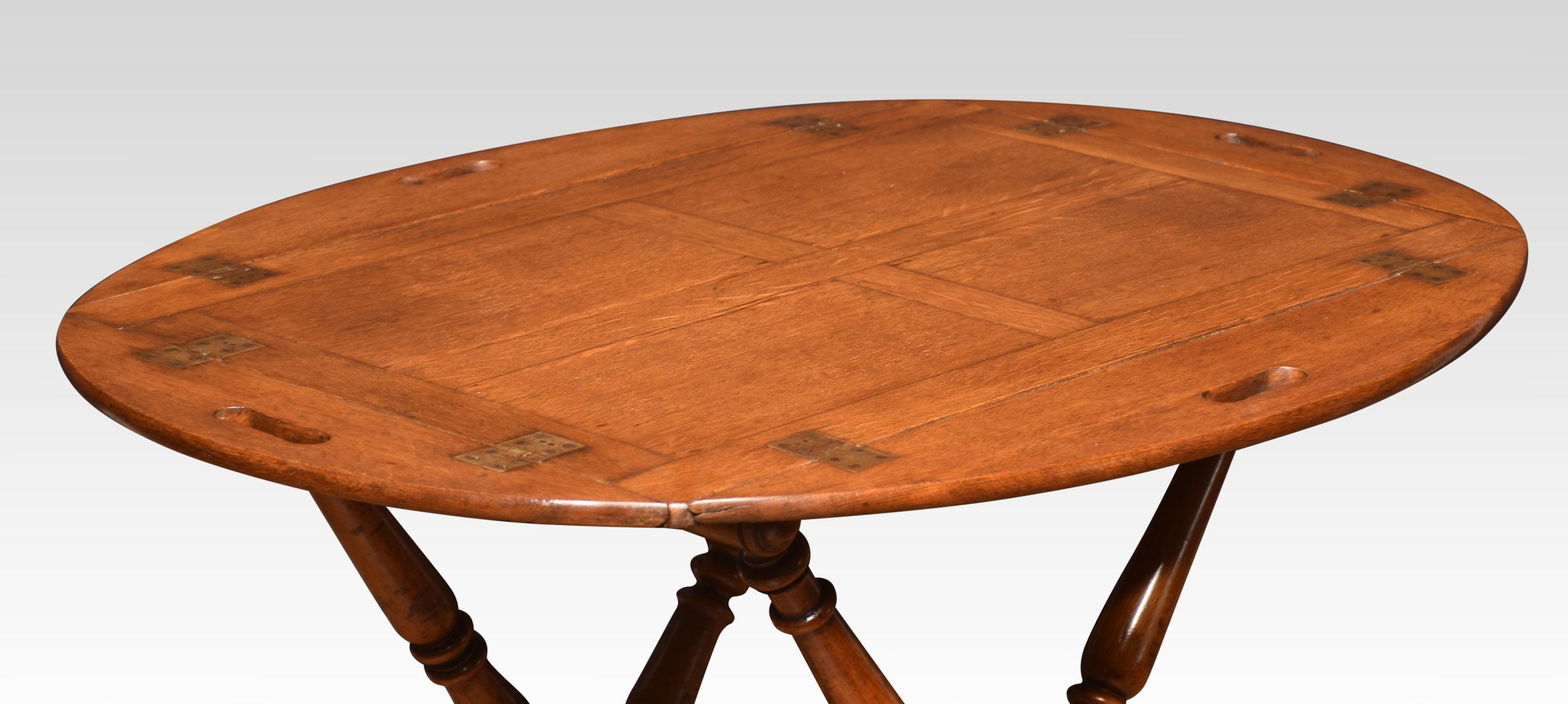 Oak butlers tray, the oval top with four hinged leaves and grab handles. Raised up on folding scissor stand with turned frame.
Dimensions
Height 30 inches
Width 37.5 inches
Depth 28.5 inches.