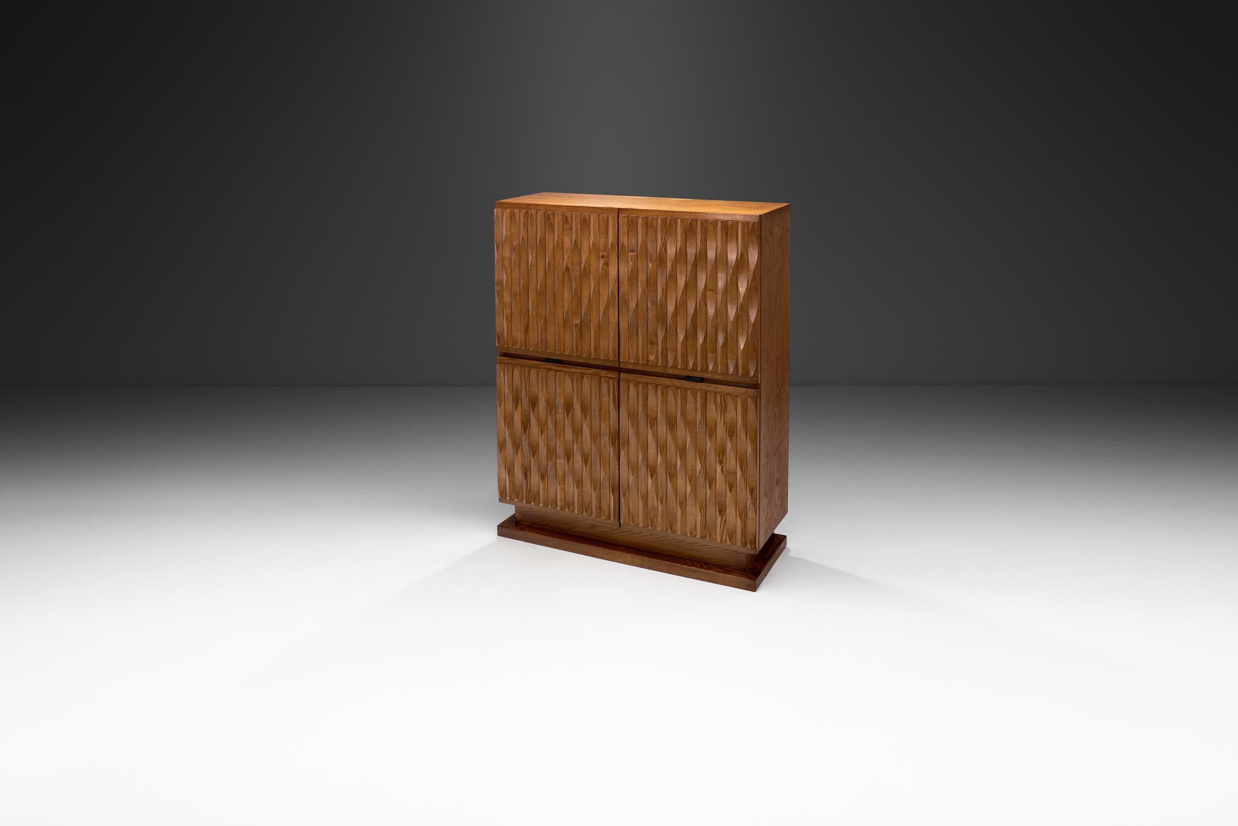 Featuring a distinctive carved motif, this cabinet melds seamlessly with any style thanks to its elegant sense of whimsy. The oak form is elemental, enhanced by the carvings and the wood itself.

In furniture design Brutalism inspired designers to