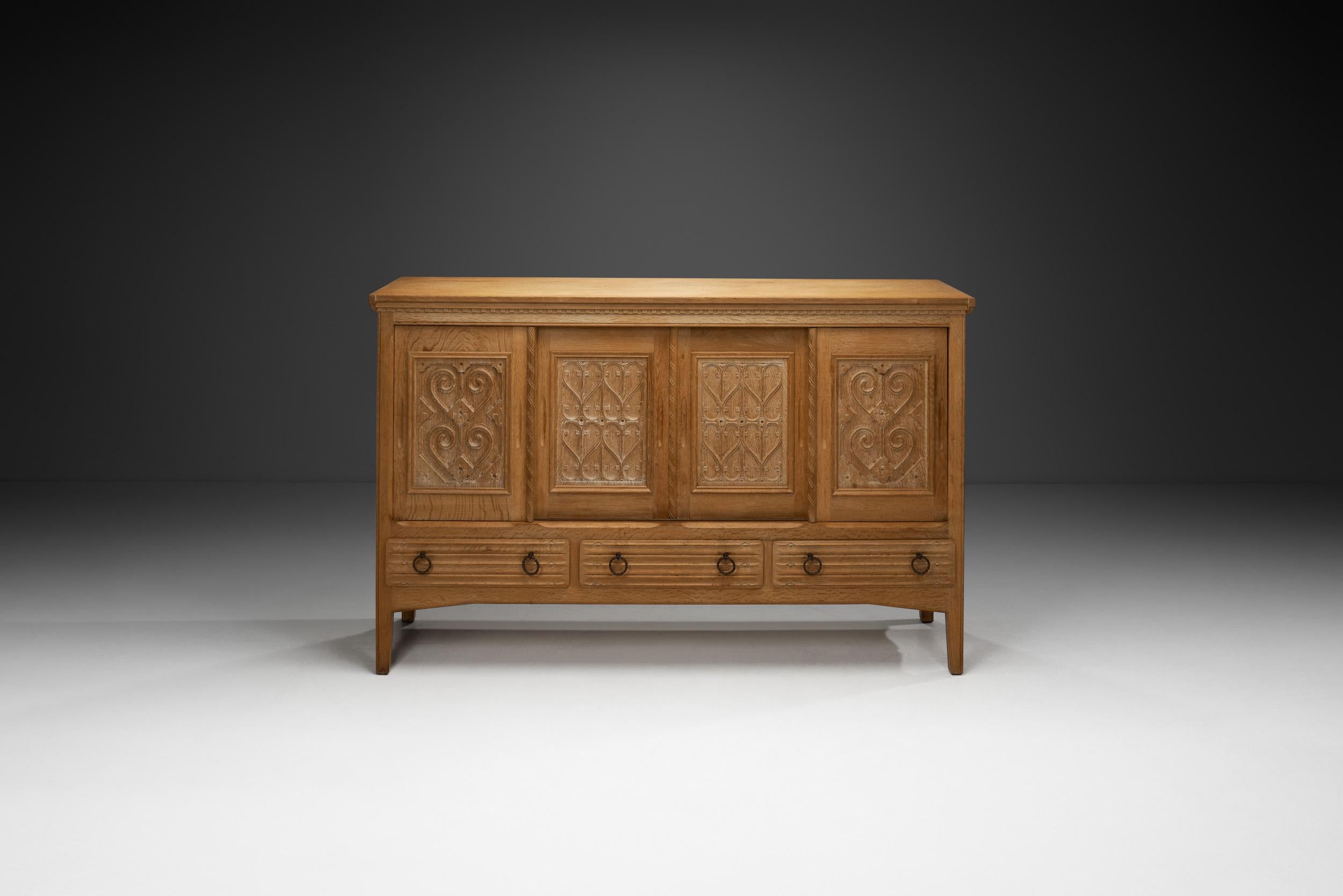 Danish Oak Cabinet with Carved Motifs by Henning Kjærnulf, Denmark Mid 20th Century For Sale