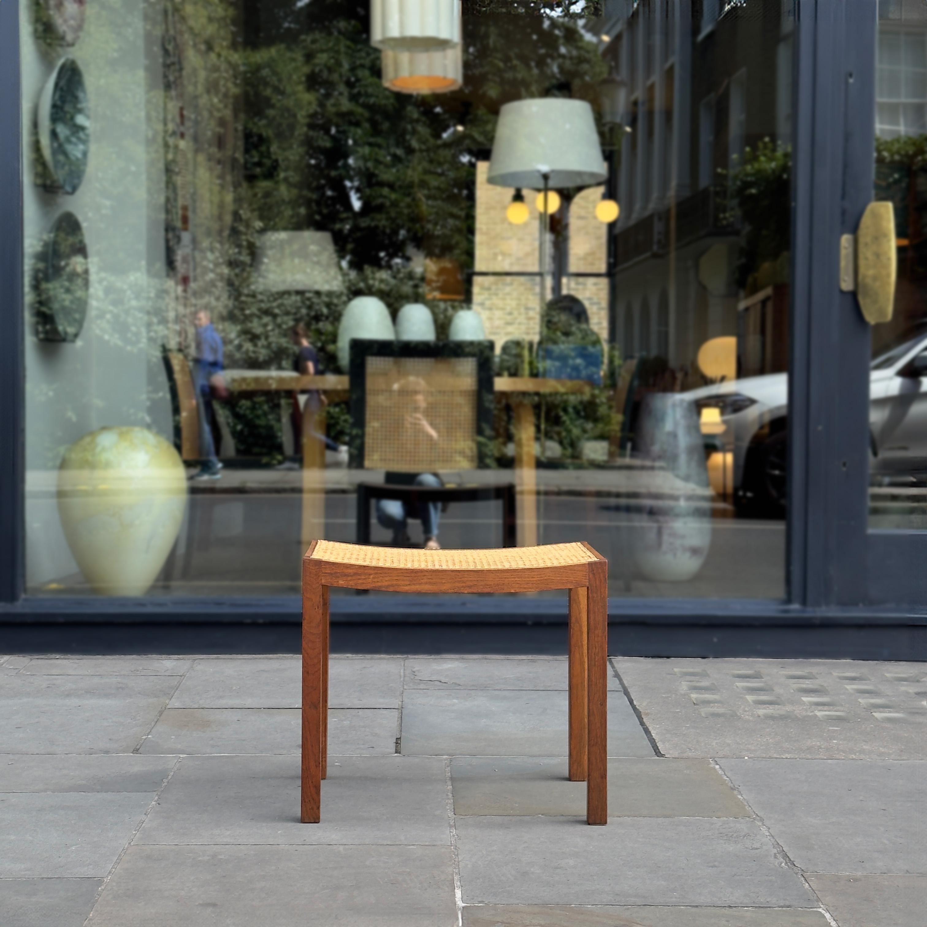 An oak piano or dressing table stool with caned seat, likely to have been made in Denmark between the late 1940s to the early 1950s. 

Slim, elegant, and functional; this mid-century oak stool is not just limited to piano players. The proportions of