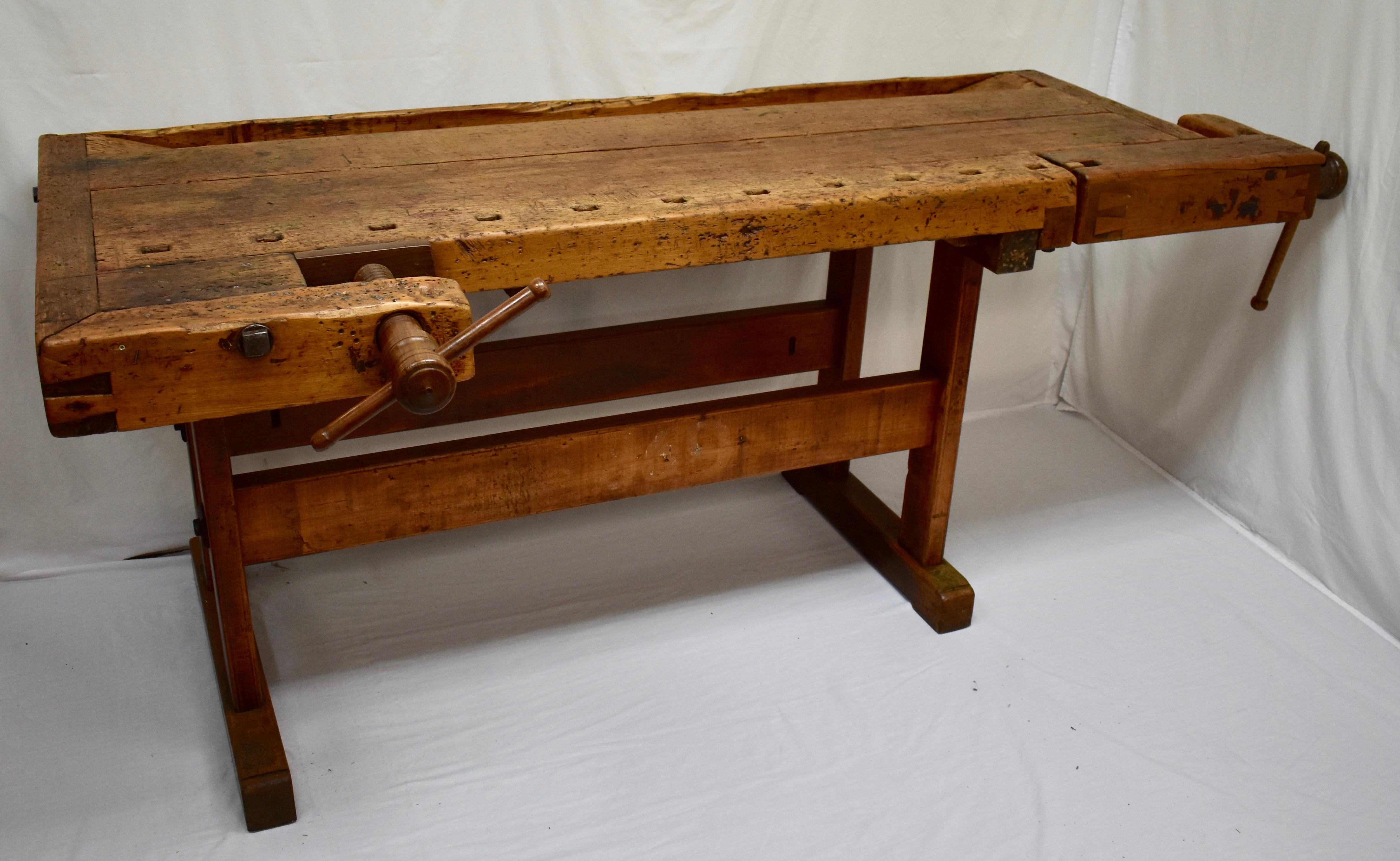 This massive oak Joiner’s workbench is built as solid as a rock and is beautifully gnarled after decades of purposeful use. The trestle-style base is made entirely of oak. The uprights are over 2”x4”, hand-cut and nicely rounded on the corners,