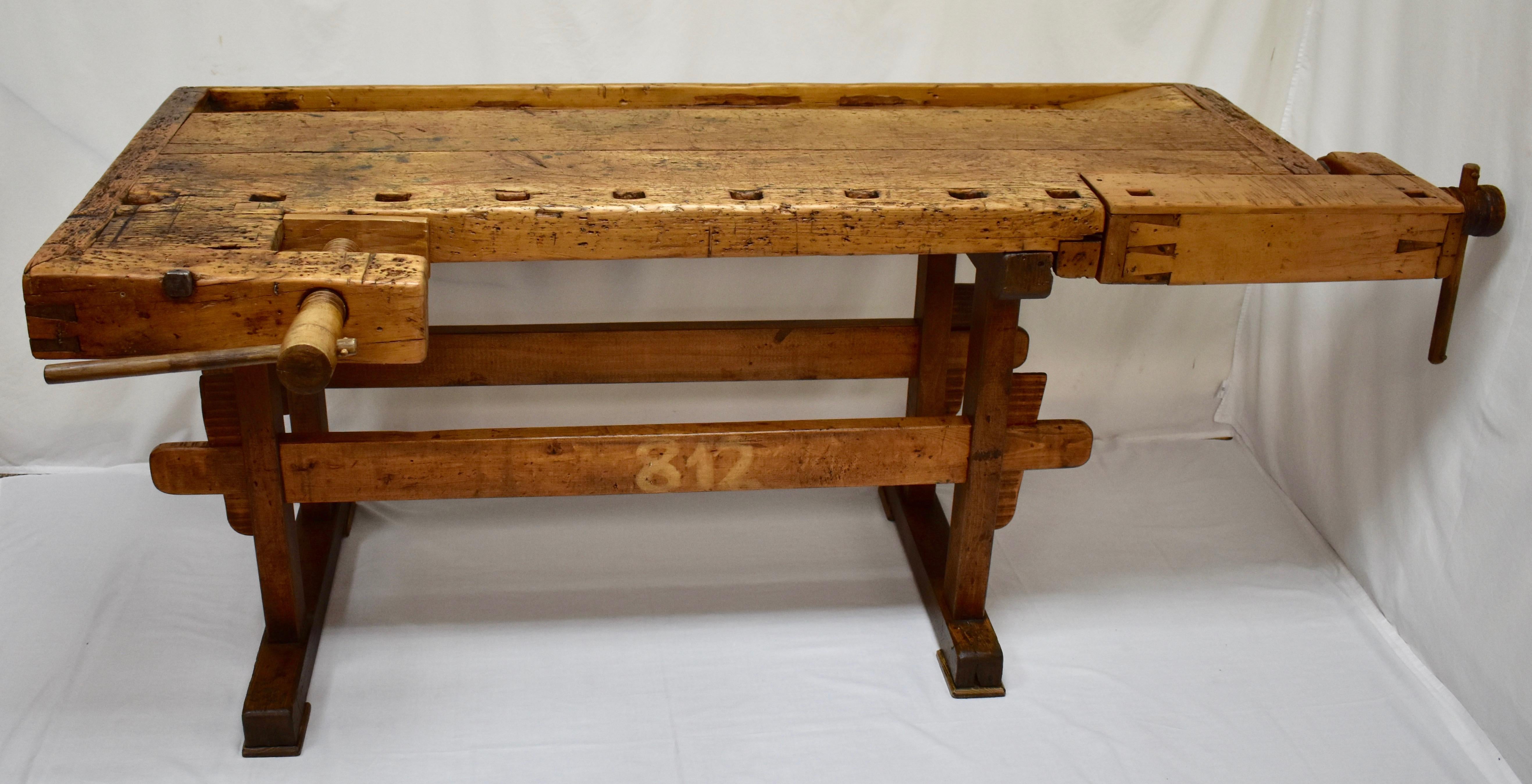 This is a magnificently gnarled joiner’s workbench, built as solid as a rock. The trestle-style base is made entirely of oak. The uprights are 3”x2”, hand-cut and chamfered on the corners, through-tenoned and pegged top and bottom to the horizontal