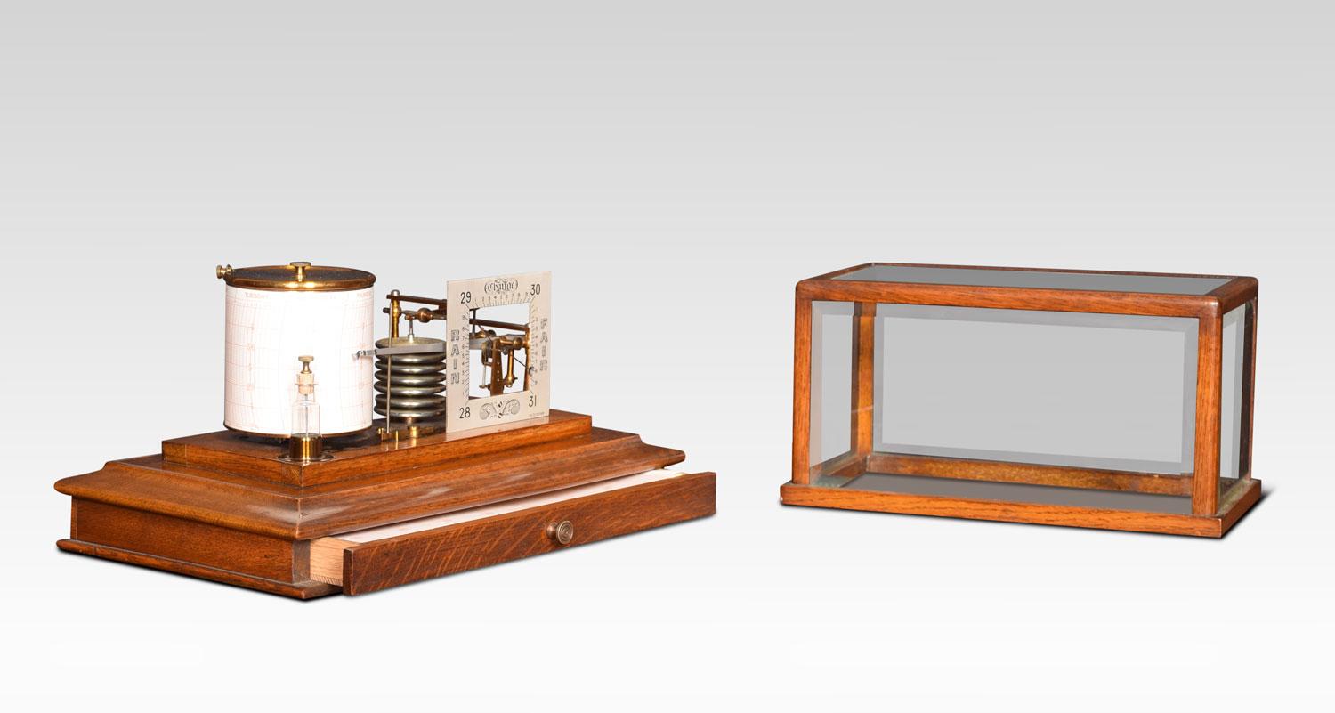 Unusual oak cased barograph and barometer, having five glazed removable lid, and a drawer below to house the charts. The mechanical eight-day movement is housed in the drum, fitted with a seven-day chart which covers one full rotation of the drum.