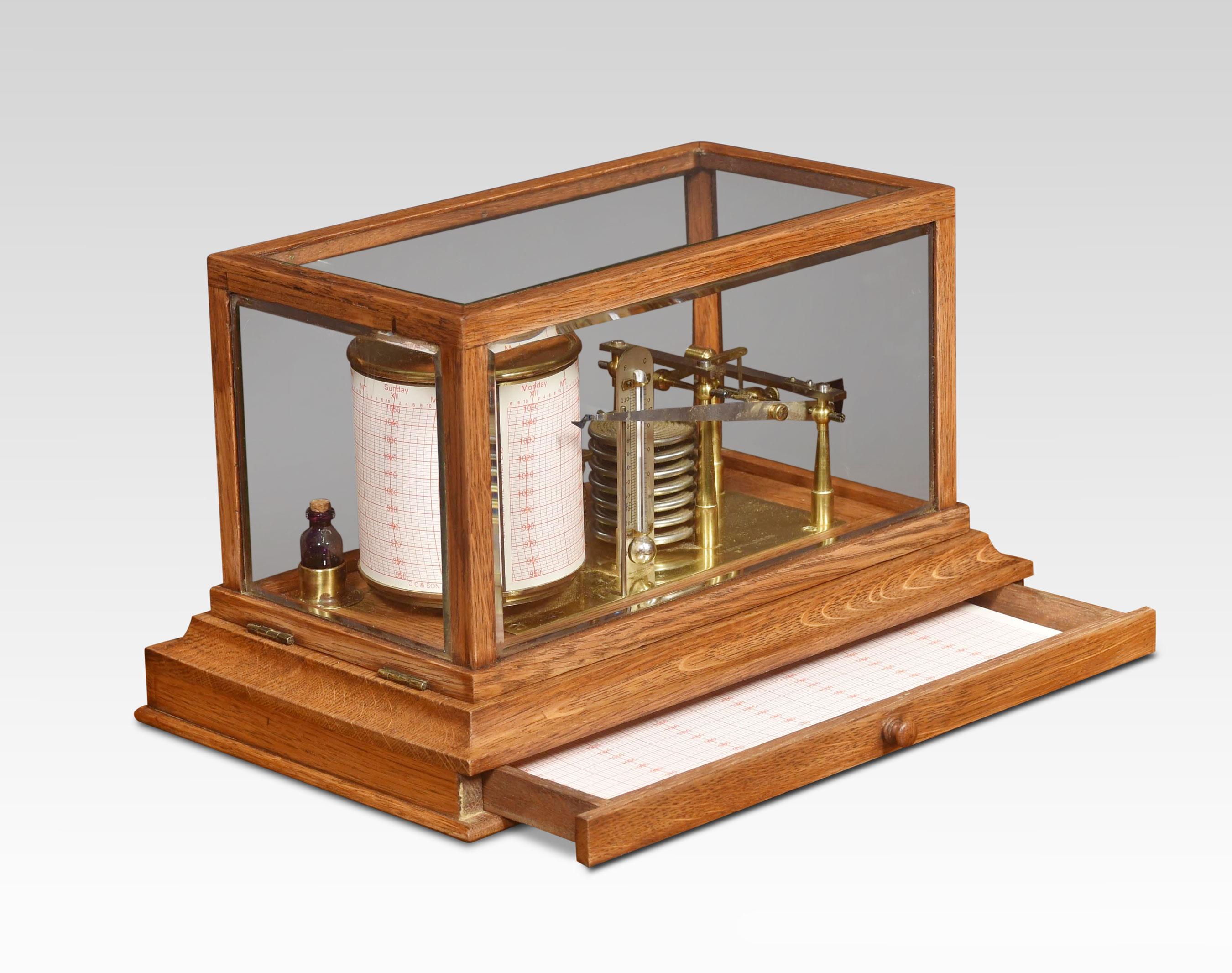 oak cased barograph and thermometer by Negretti & Zambra, having a hinged five-beveled glazed removable lid. The mechanical eight-day movement is housed in the drum, fitted with a seven-day chart that covers one full rotation of the drum. The ink