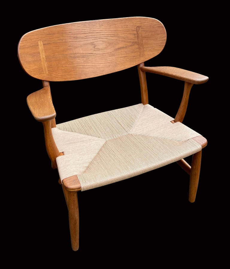 This is a beautiful early example of a scarce design by Hans J. Wegner, and produced by Carl Hansen, in very good original condition, lovely patina and perfect papercord. There is a stamp beneath one arm which says B C 69, not sure of the