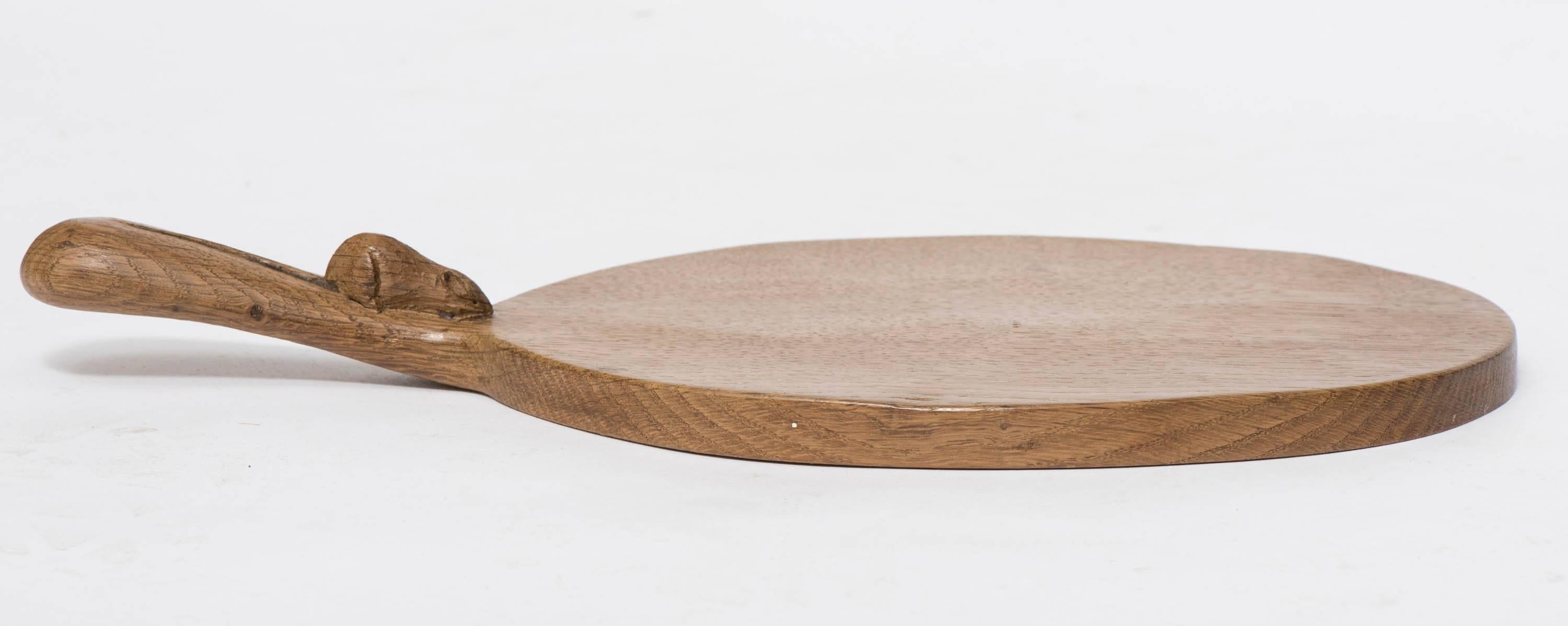 An oak cheese board by Robert Thompson “Mouseman”
Carved mouse to the board
adzed
English
circa 1960
Measures: 37 cms W 17.5 cm x 2 cm.
 