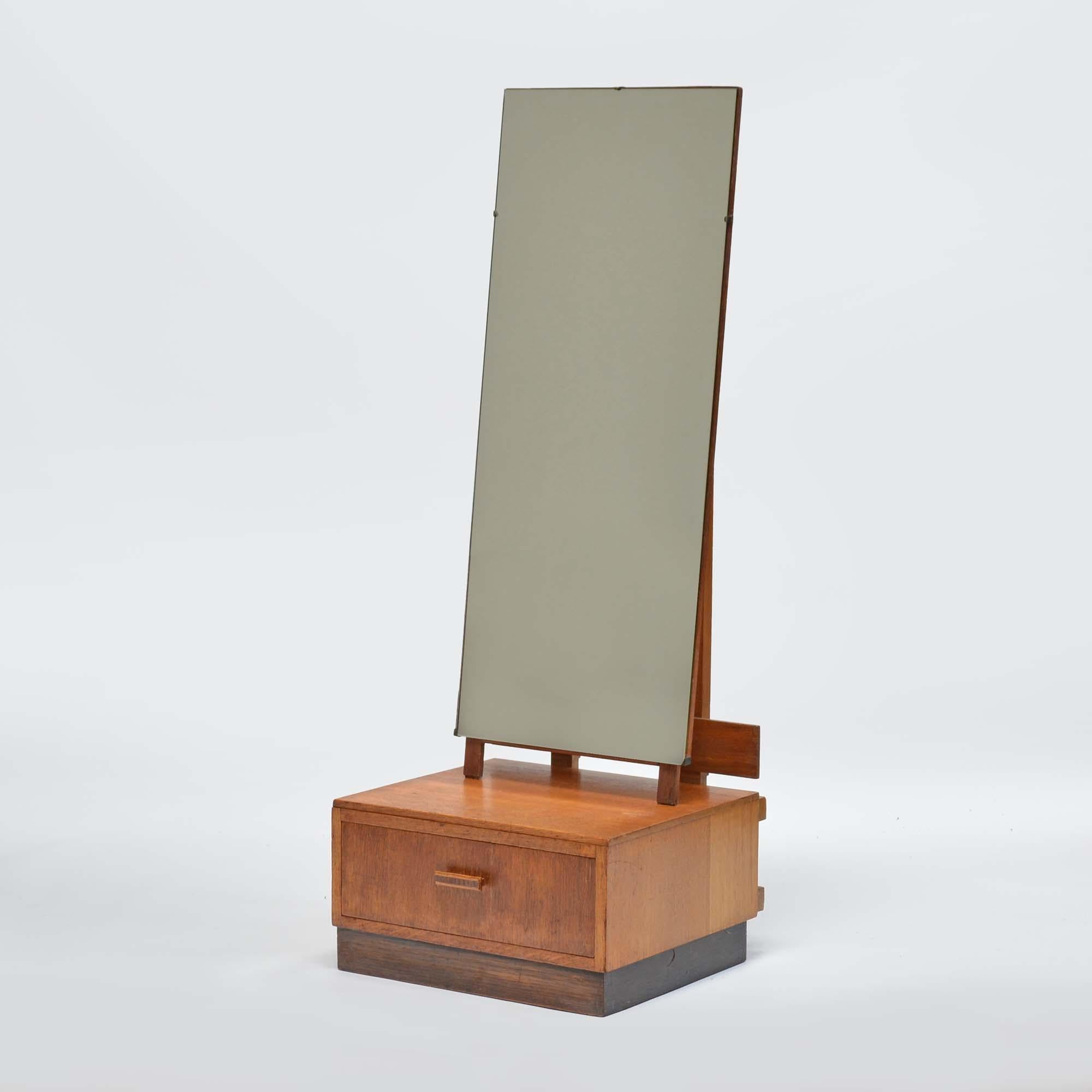 Oak cheval dressing mirror in the manner of Heals
By A.B. Ltd, 'Good Furniture Units' who took their inspiration from Heals producing good quality household furniture, label to base.  The bevelled mirror plate is hinged from the top with a simple