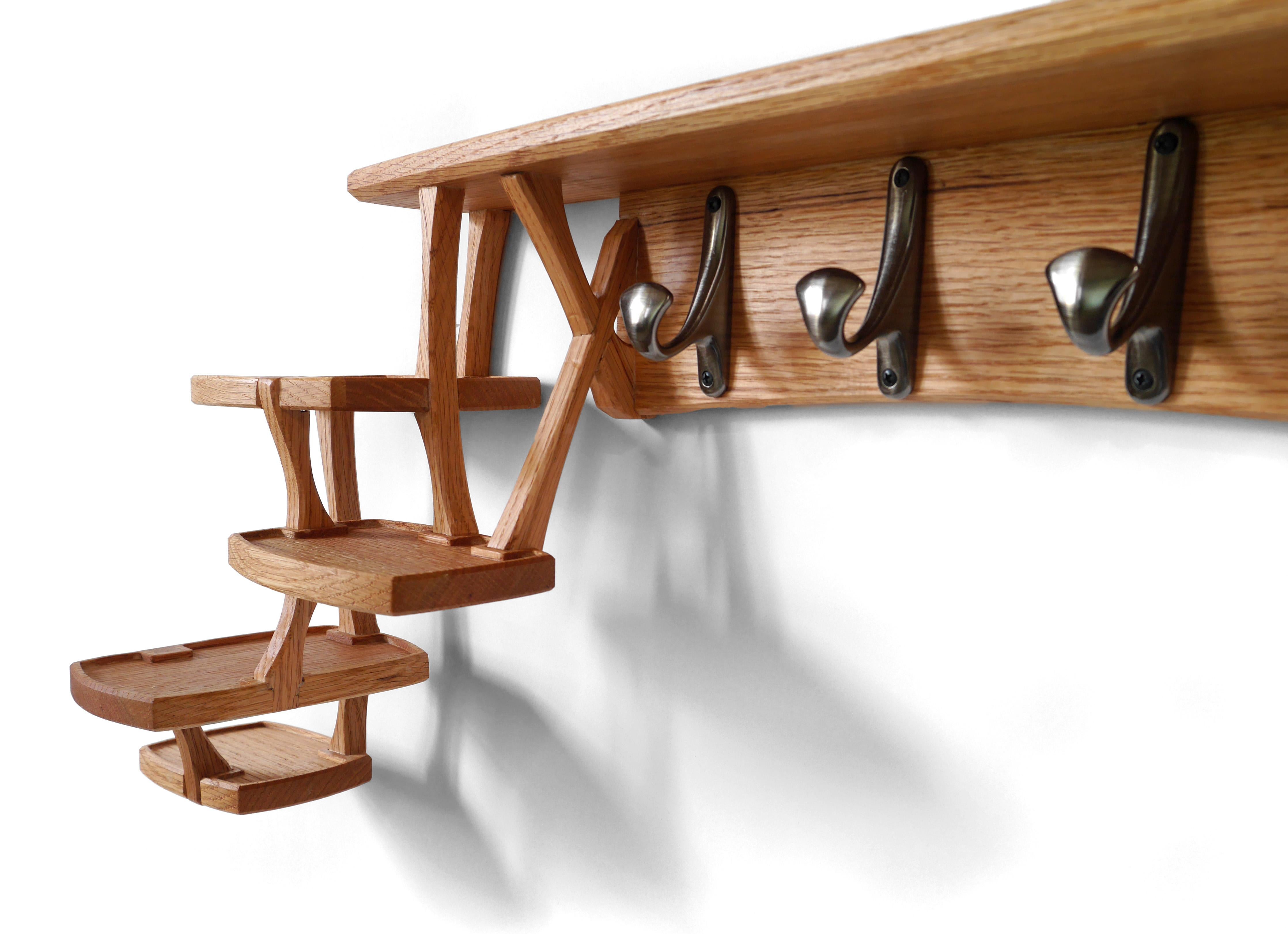 The Cirrus Coat Rack is wall mounted with seven hooks for coats, hats, or backpacks, and a series of small shelves for keys, a wallet, or whatever tools or accouterments you take with you into the world. It’s made out of solid oak hardwood and built