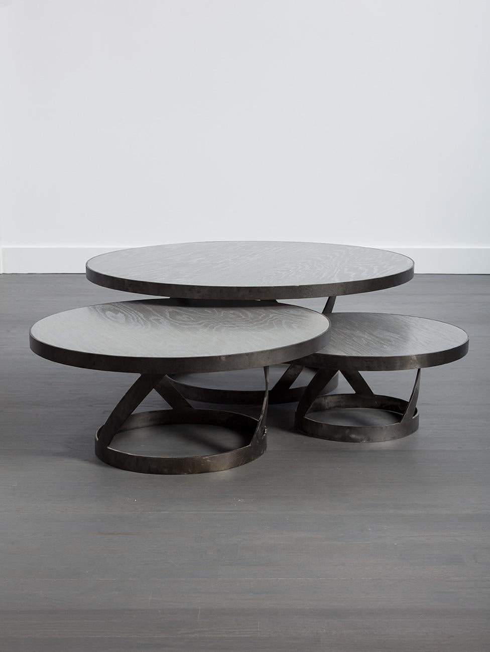This versatile modern oak coffee table with a blackened steel spiral base provides great interest for the family or living room. Shown is the 42 inch diameter table top. The table also comes in 31 and 24 inch diameters and varying heights,