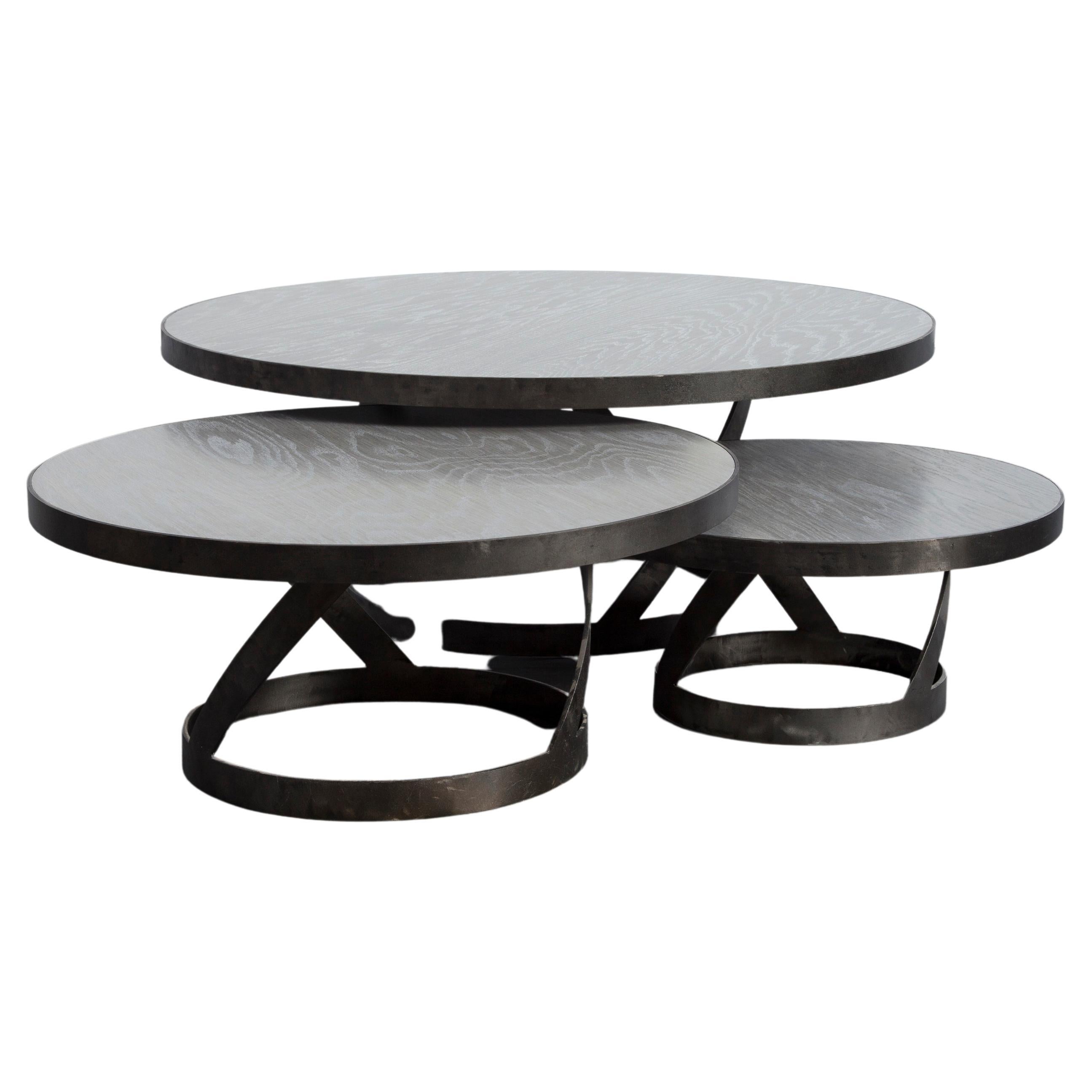 This versatile modern oak coffee table with a blackened steel spiral base provides great interest for the family or living room. Shown is the 24 inch diameter table top which is the smallest size offered. The table also comes in 31 and 42 inch