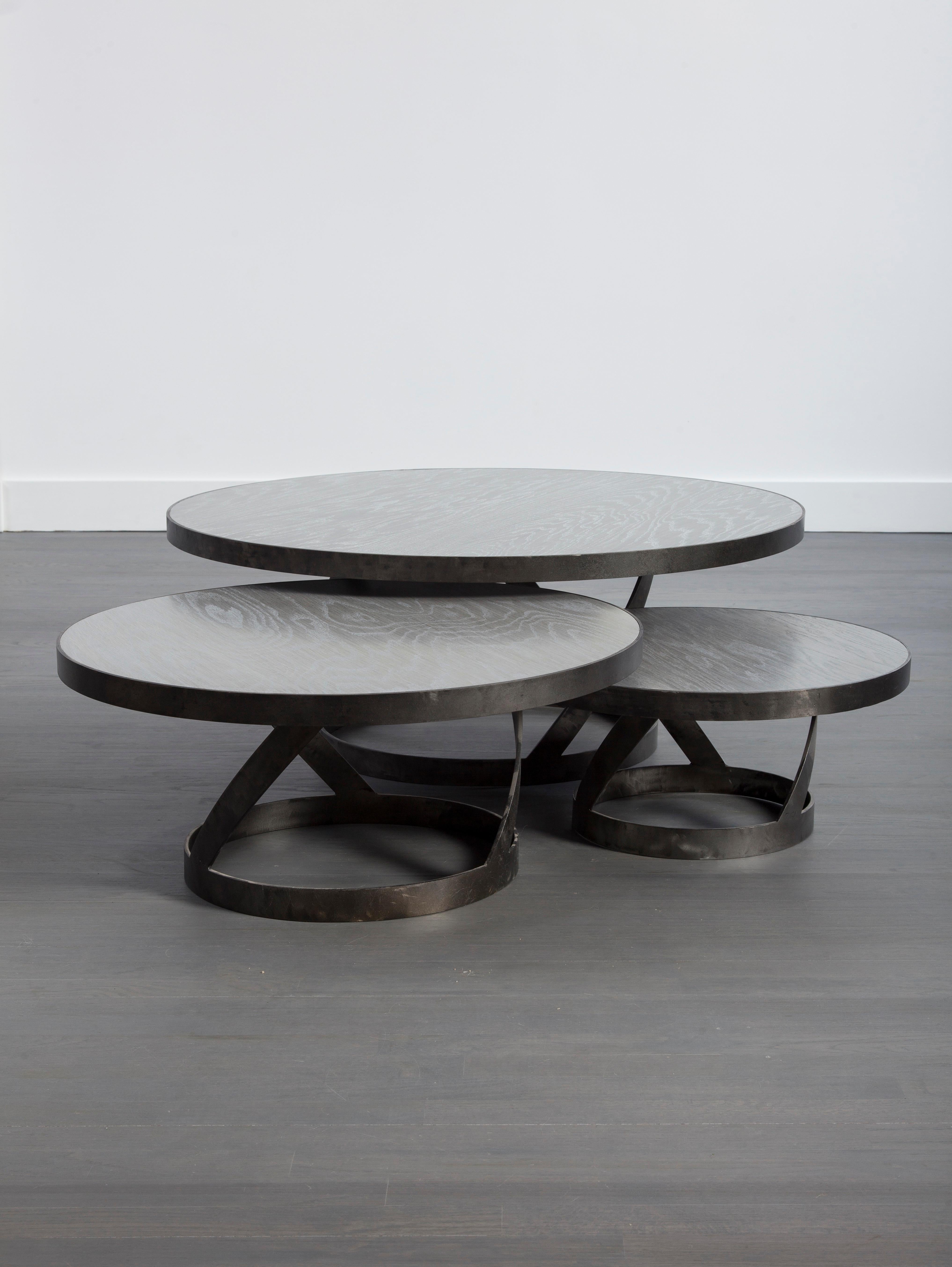 This versatile modern oak coffee table with a blackened steel spiral base provides great interest for the family or living room. Shown is the 31 inch diameter table top. The table also comes in 42 and 24 inch diameters and varying heights,