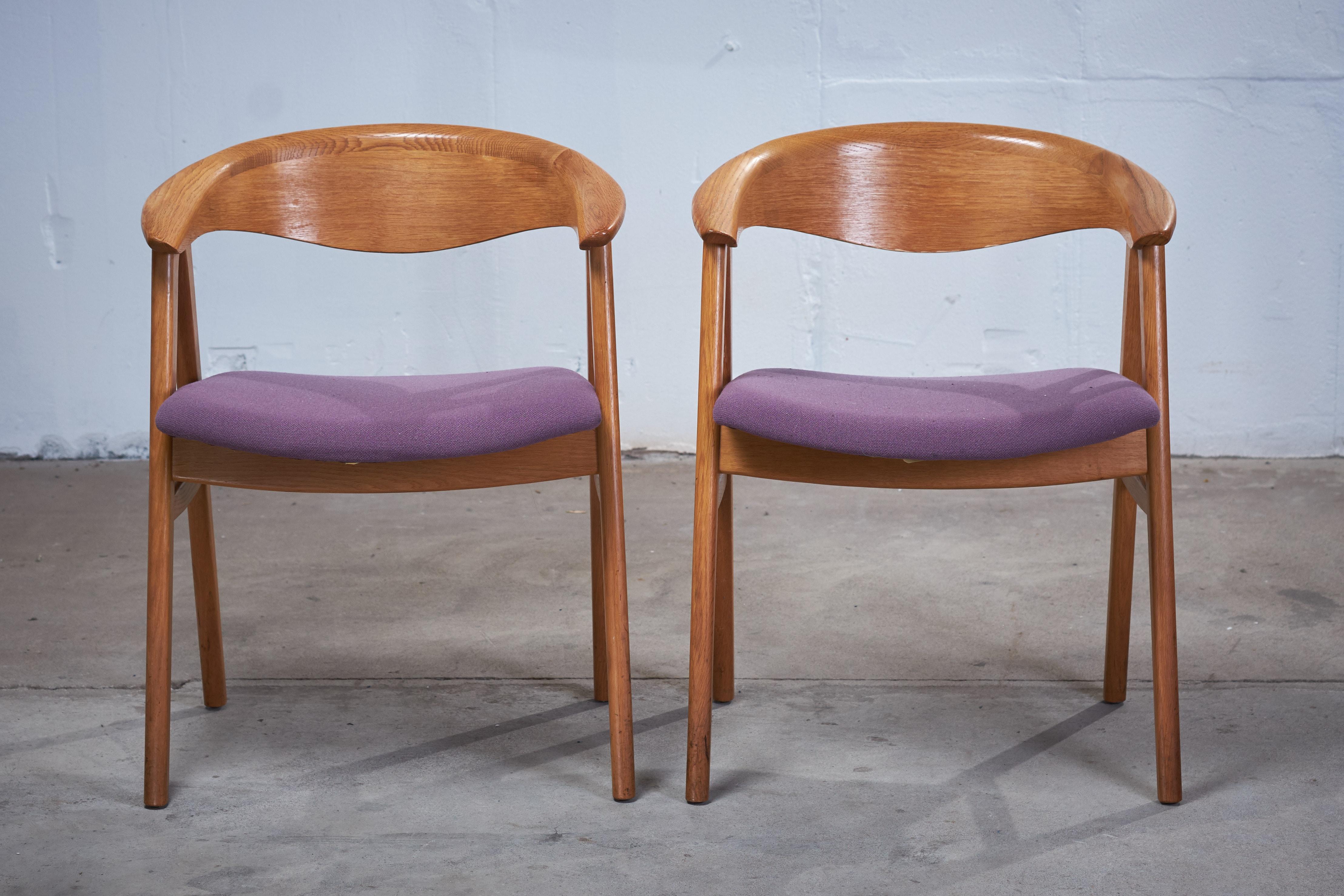 This pair of Erik Kirkegaard armchairs in oak was designed in 1952, 'Model 52' for Høng Stolefabrik. The chairs has a generous, curved backrest with a wide lip and a seat with good quality wool, supported between two A-frame legs of solid oak. The