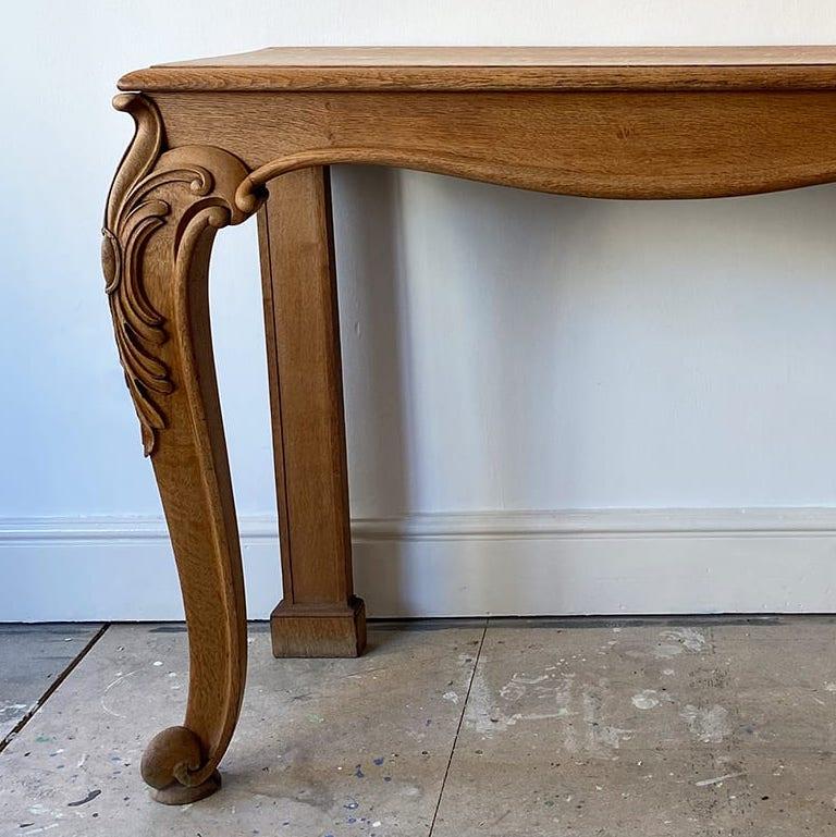 An elegant light oak console table on carved cabriole legs.
C.1860
Measures: H91cm x W128 cm x D52 cm.
