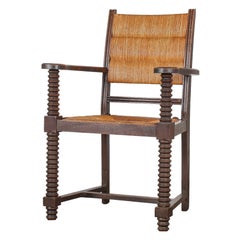 Fauteuil en chêne tire-bouchon des années 1950 avec assise en paille attribué à Charles Dudouyt