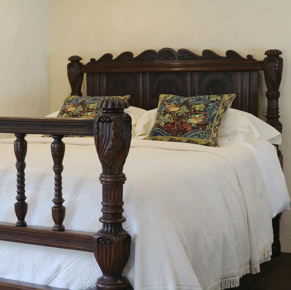 Oak country style bed with turned front posts, spindle foot board and carved head panel depicting heads of wheat.

The bed accepts a British king size or American queen size (60 inches, 5ft or 150 cm wide) base and mattress.

The price is for