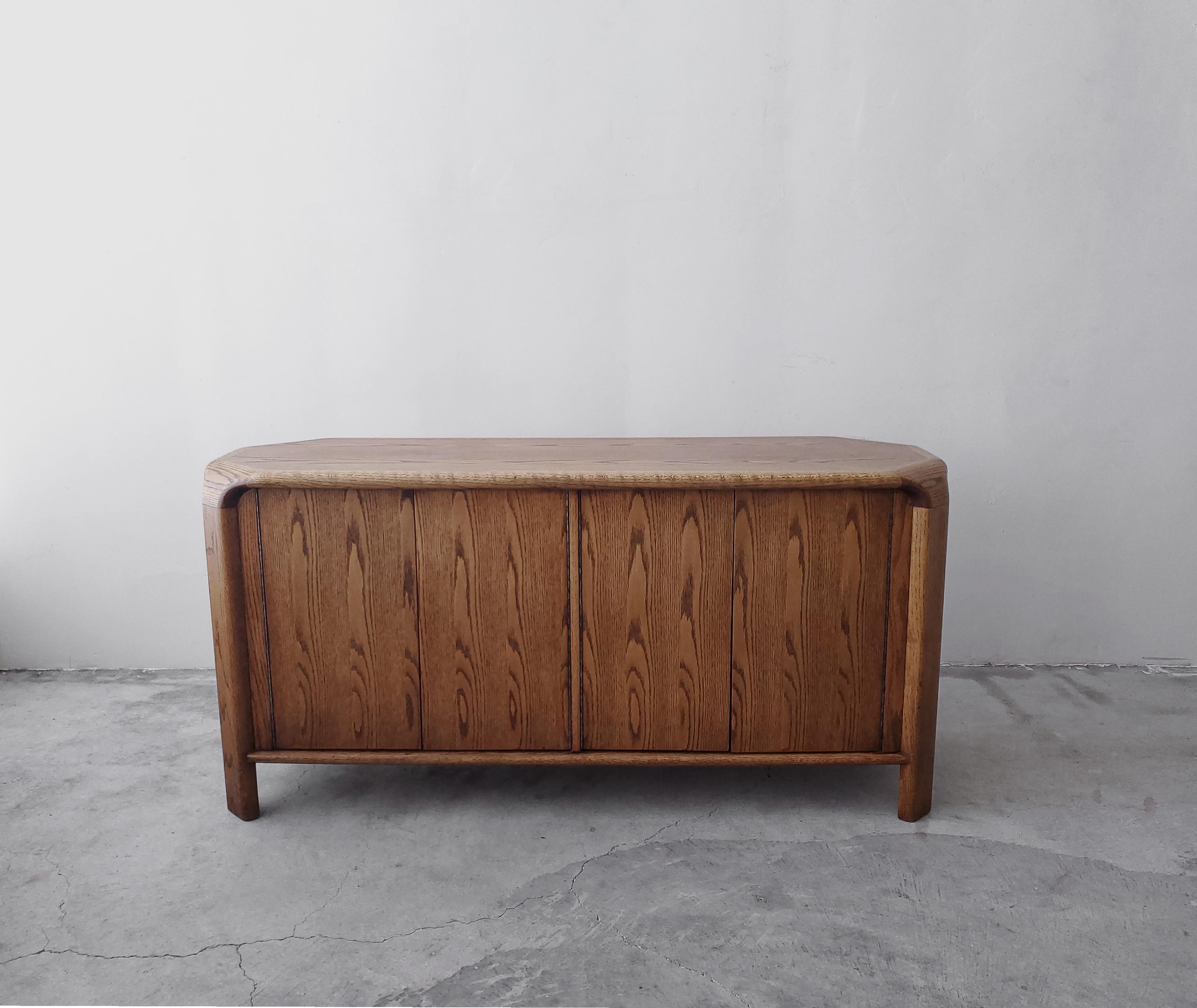 I love the simplicity of oak and this beautiful Lou Hodges piece is no exception. The cabinet is constructed out of beautifully grained oak, the rounded edge details give this piece quite a bit of visual interest. And the finished back allows it to