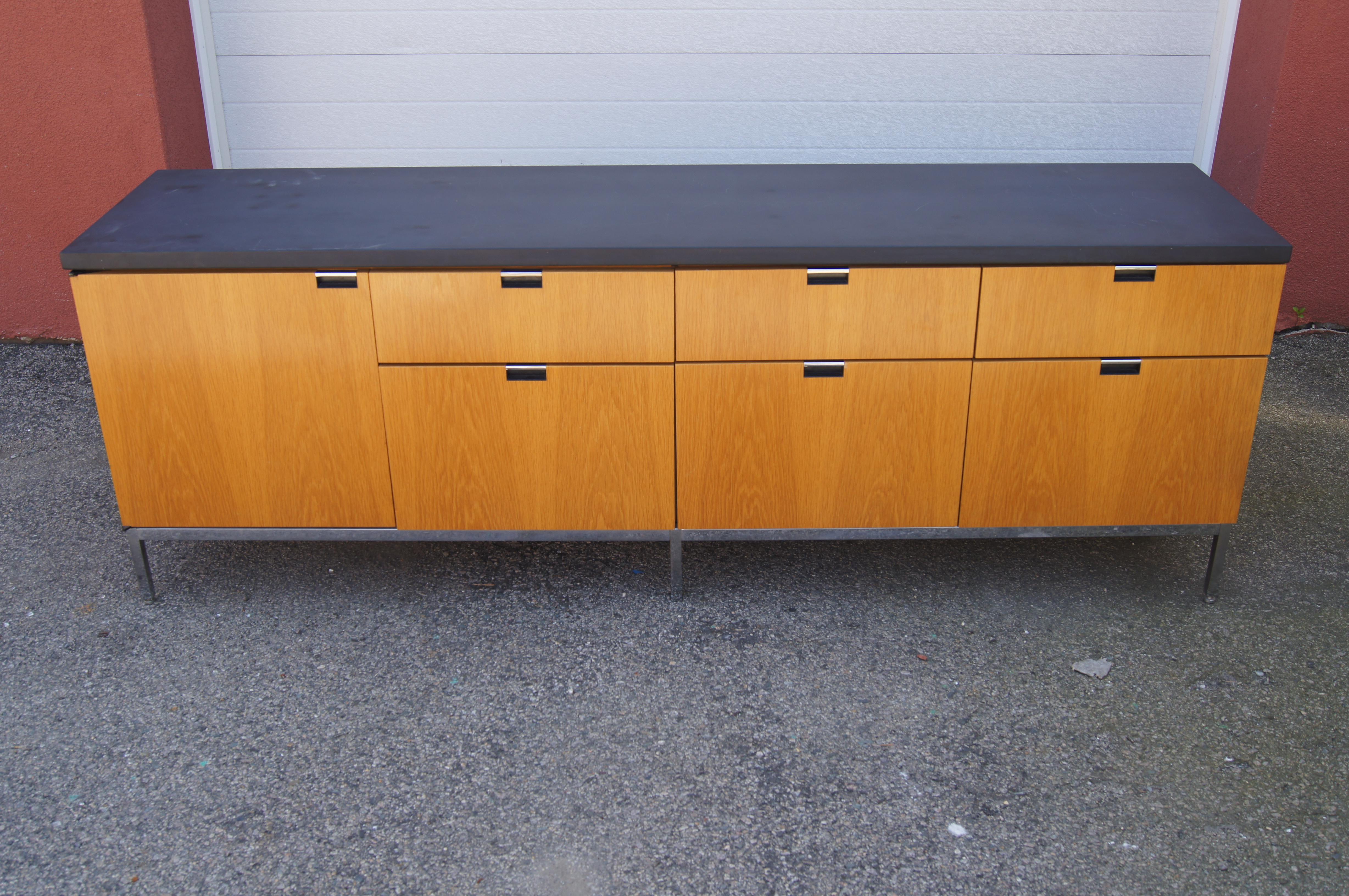 Designed by Florence Knoll for Knoll, this iteration of her classic clean-lined credenza features a warm oak case sitting on slender chrome legs and topped with contrasting slate. Inset chrome pulls open six drawers: three file-sized with metal