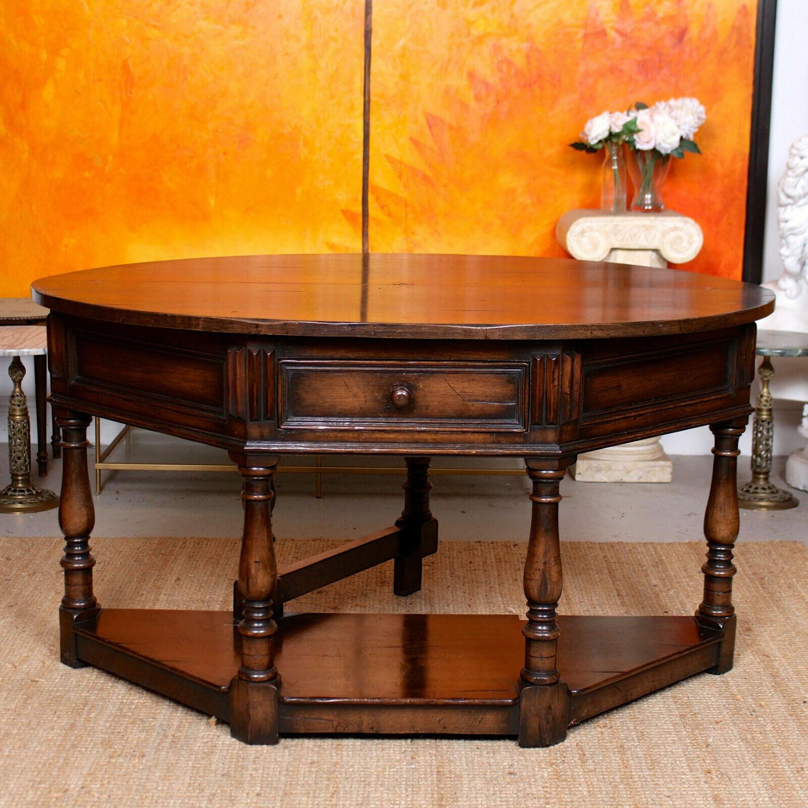 An impressive well carved oak creedence table in the 17th century manner.

The folding top with well carved edges - extending by way of gateleg action - fitted a drawer to frieze and raised on fluted turned legs.