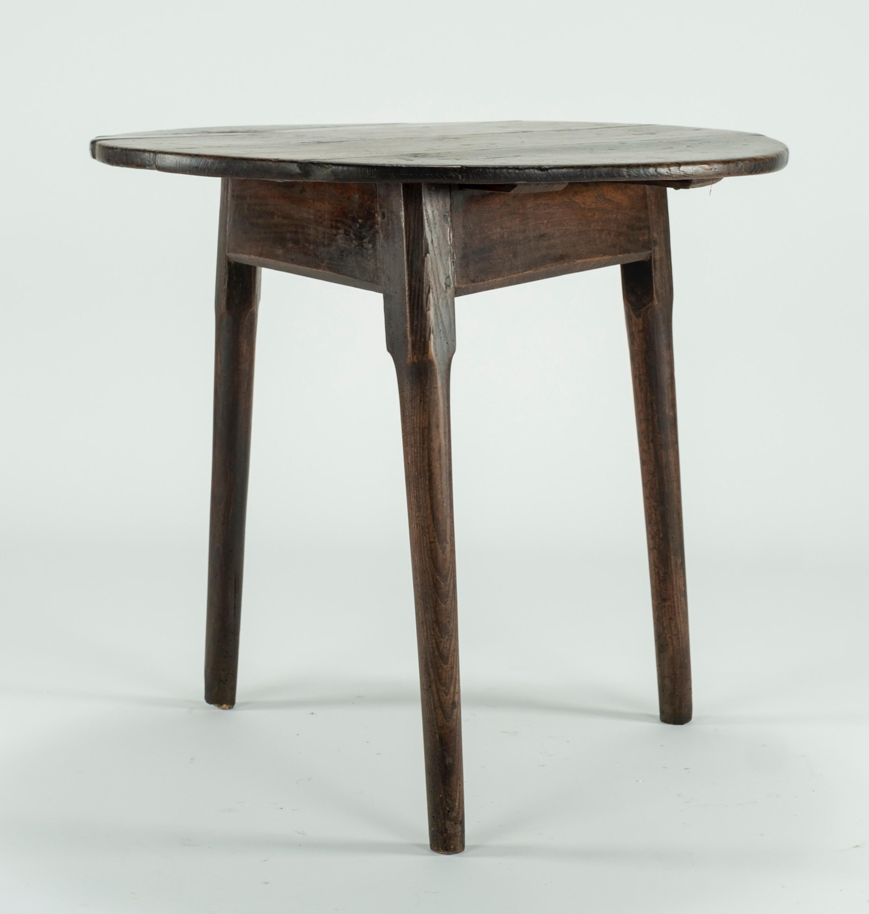 Good George II oak cricket table with circular top and standing on three plain 'pole' legs. Great rich color with stunning waxed patina. A lovely rustic item.
