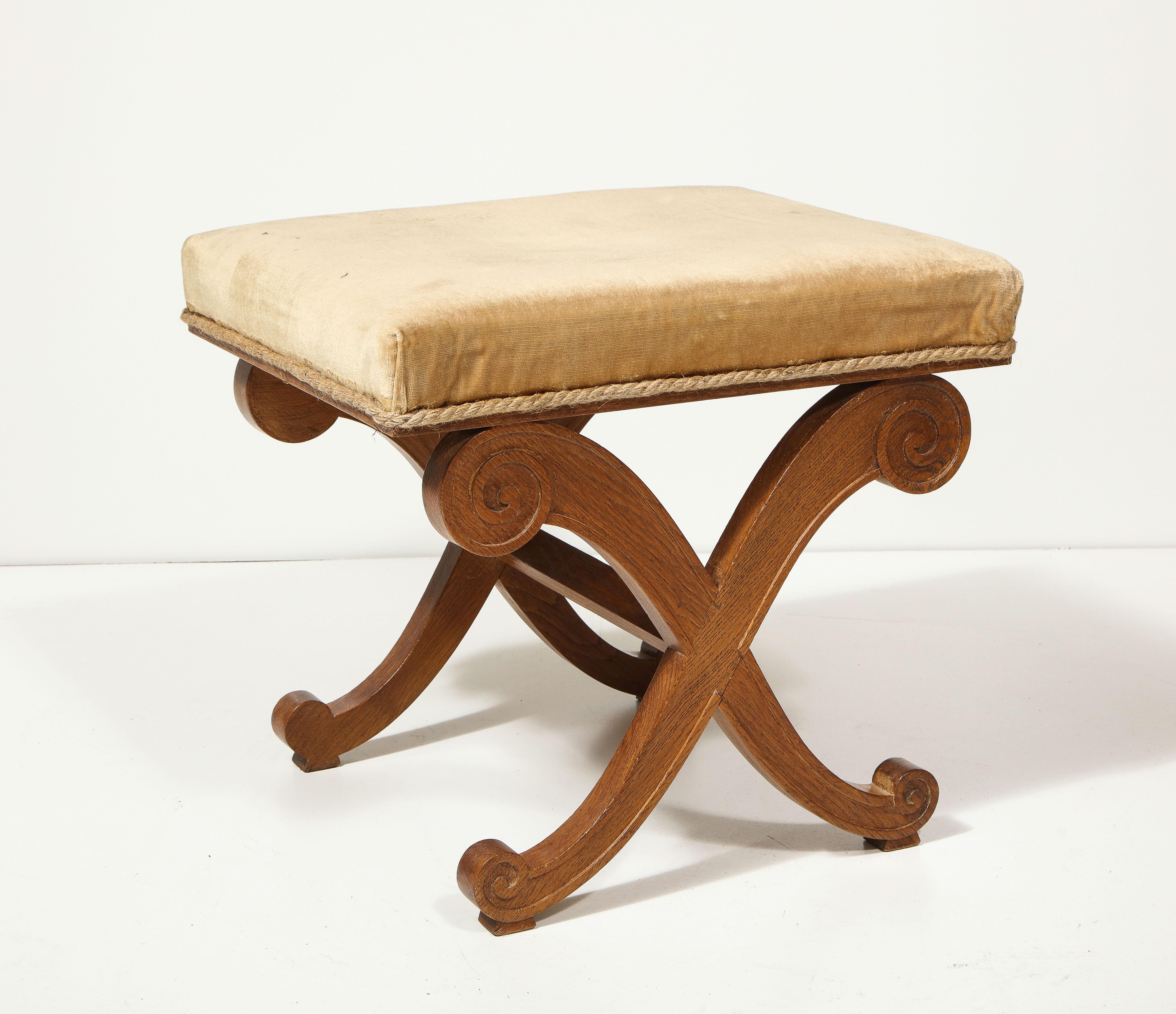 Carved and upholstered oak curule stool/ottoman.