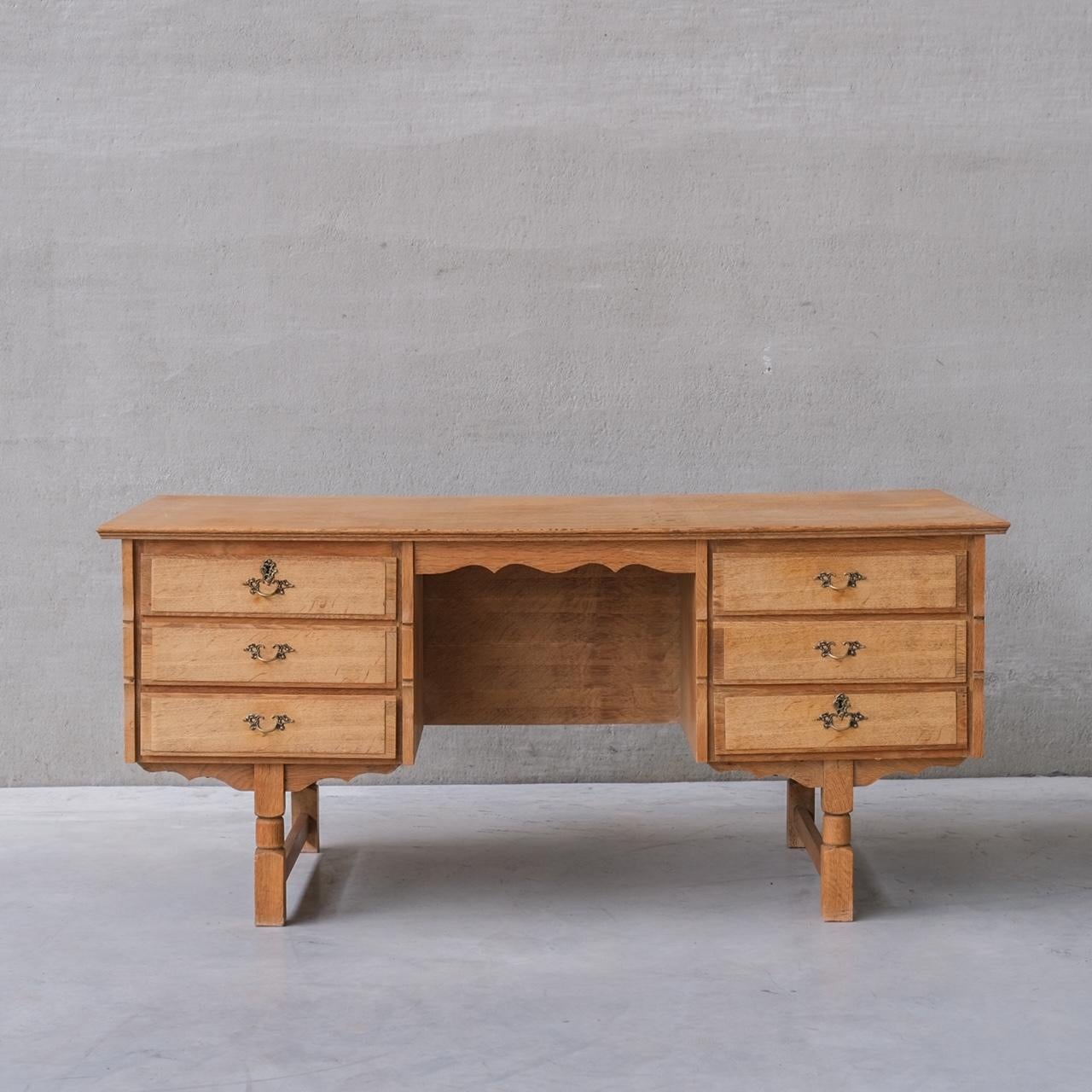 A good looking simple desk, in oak, with reverse shelf for displaying books or curios.

Denmark, circa 1960s.

Attributed to Henning Kjaernulf.

Good vintage condition. Some scuffs and patina commensurate with age.

Location: Belgium