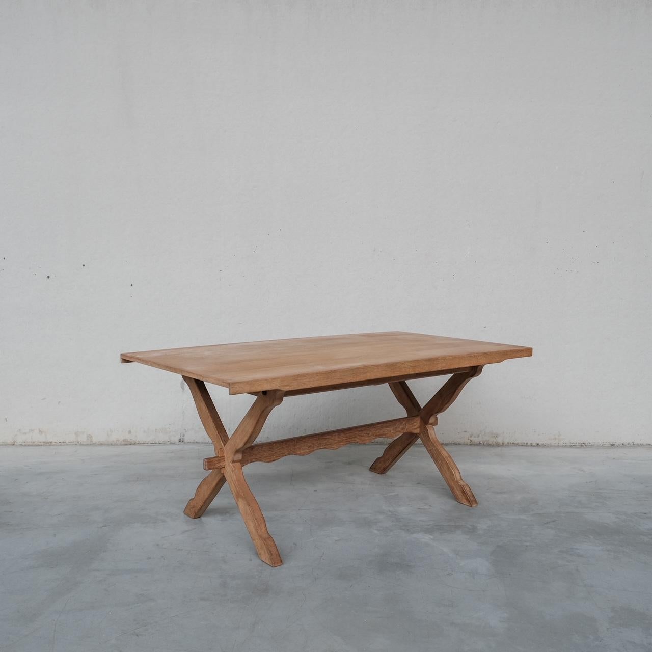 An x-frame dining table attributed to Henning Kjaernulf. 

Denmark, c1960s. 

Pleasing details such as the wobbly carved stretcher. 

Good vintage condition, some scuffs and wear commensurate with age. 

Internal Ref: 07/03/24/001.

Location: