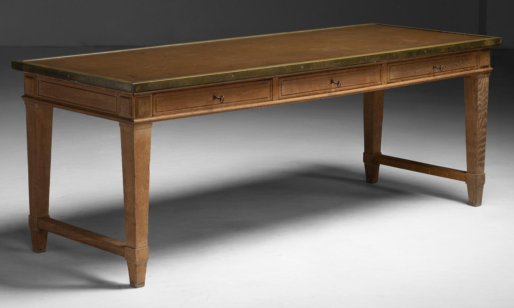 Oak Desk

France, 1930

Oak desk with an inset leather writing surface and brass surround. Features three shallow drawers with keys, tapered legs, and side stretchers.

79”w x 30”d x 30”h

Ref. DESK505