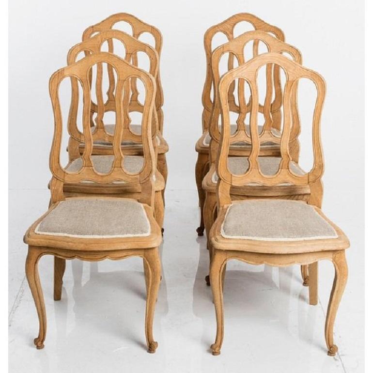 Set of six French country dining chairs, circa 1900. Bleached oak and recently reupholstered.