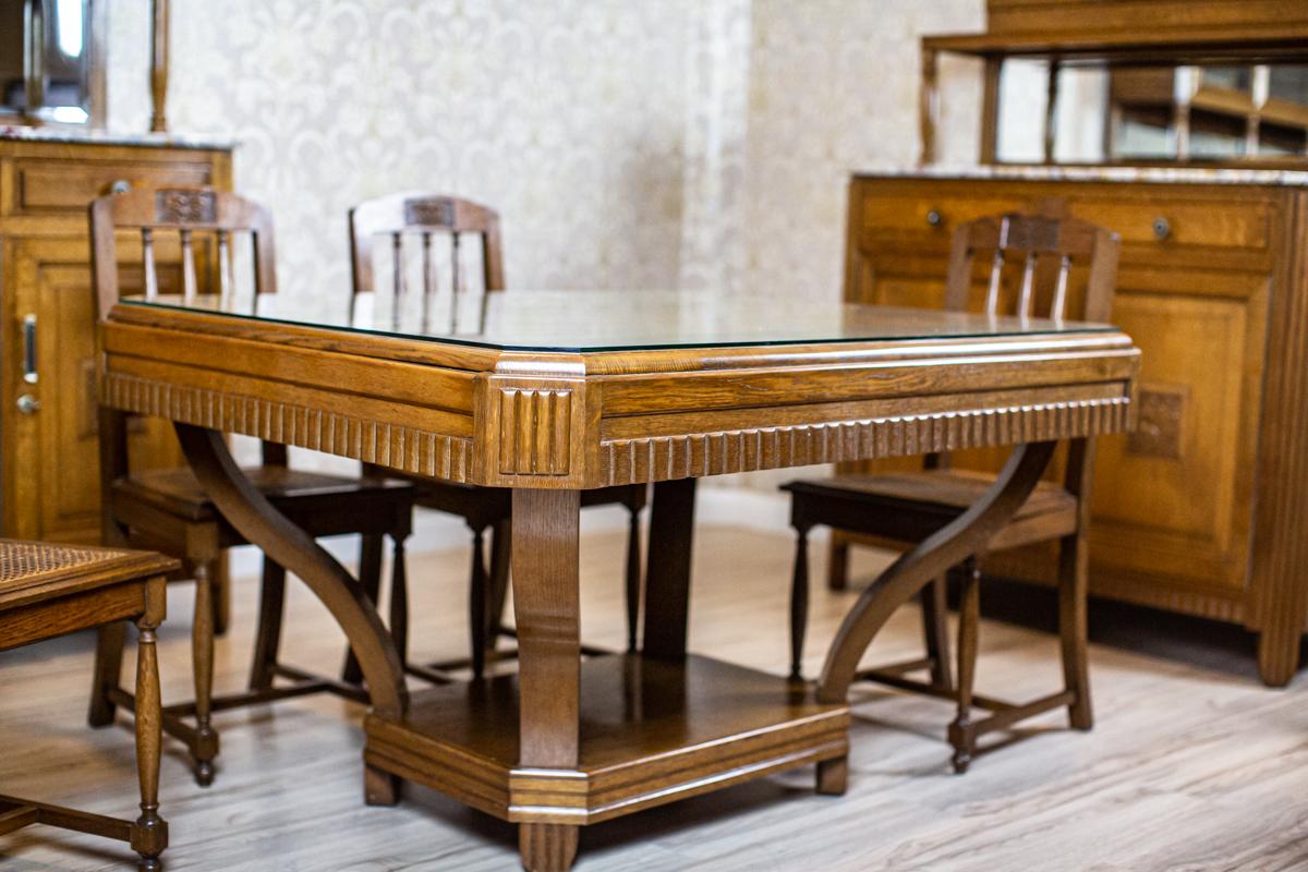 Oak Dining Room Set from the Early 20th Century with Marble and Rattan Elements

The buffet is three-door, with drawers on the door axis and a removable add-on unit.
There is a mirror along the whole width of the rear wall of the add-on