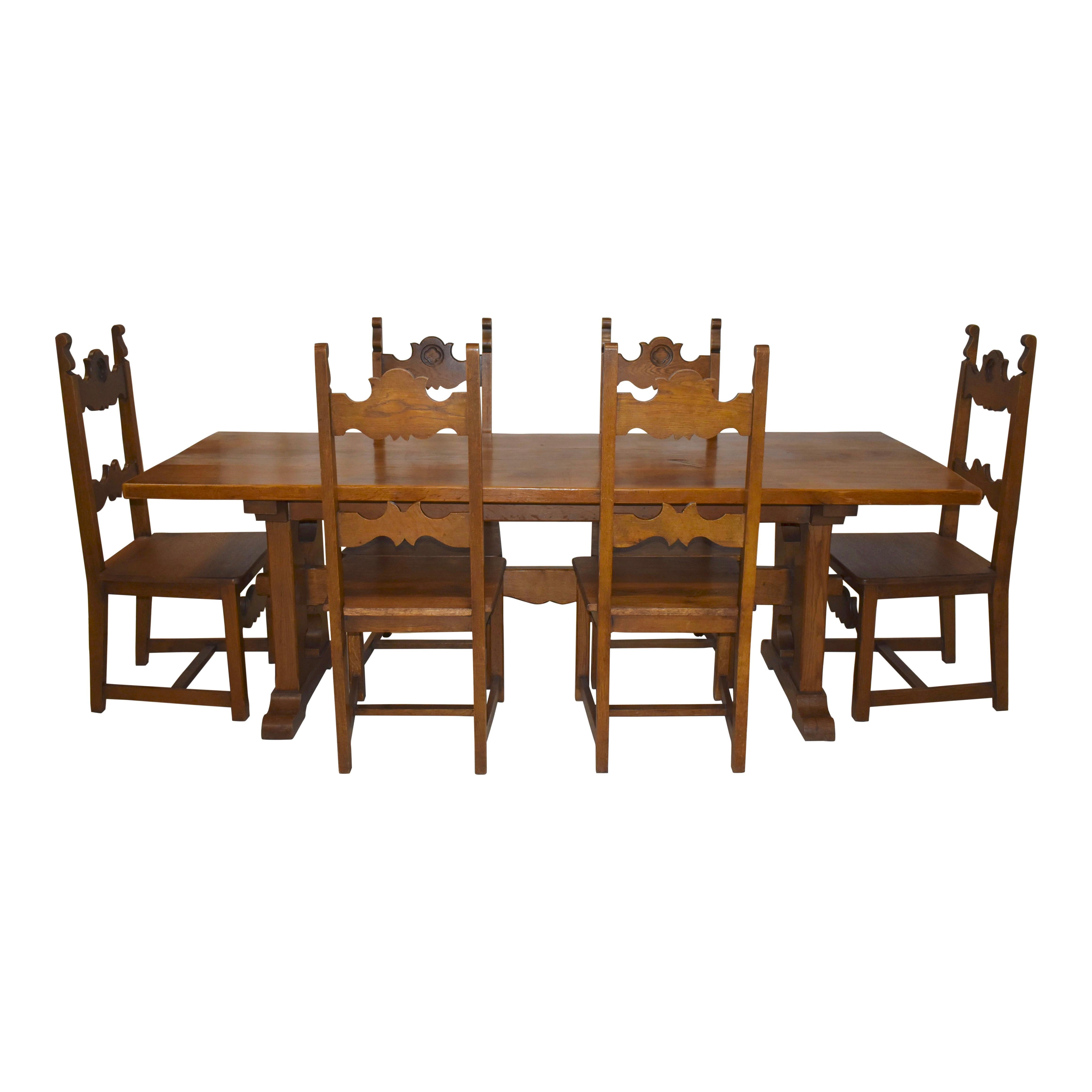 Gather family and guests around this warm and inviting farm table. Constructed of solid oak, the table features shaped legs, joined by a scalloped trestle using tusk tenon joinery, which provides additional support and style. The chairs feature