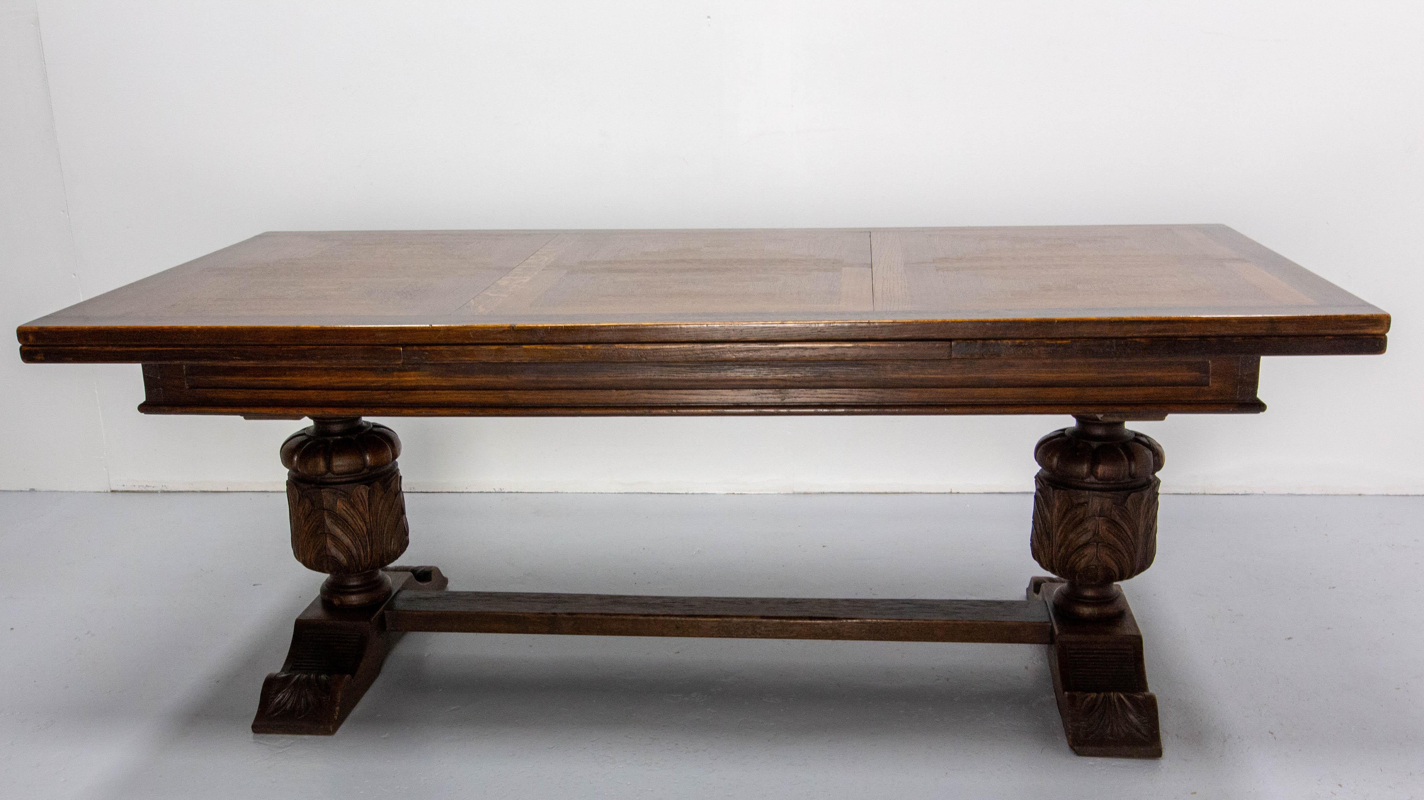 French Spanish Basque Renaissance Revival dining table 1960
Carved oak solid wood. The table top is decorated in a checkerboard pattern thanks to a play on the direction of the wood.
With the extensions the size of the table increases from 78.74 in.