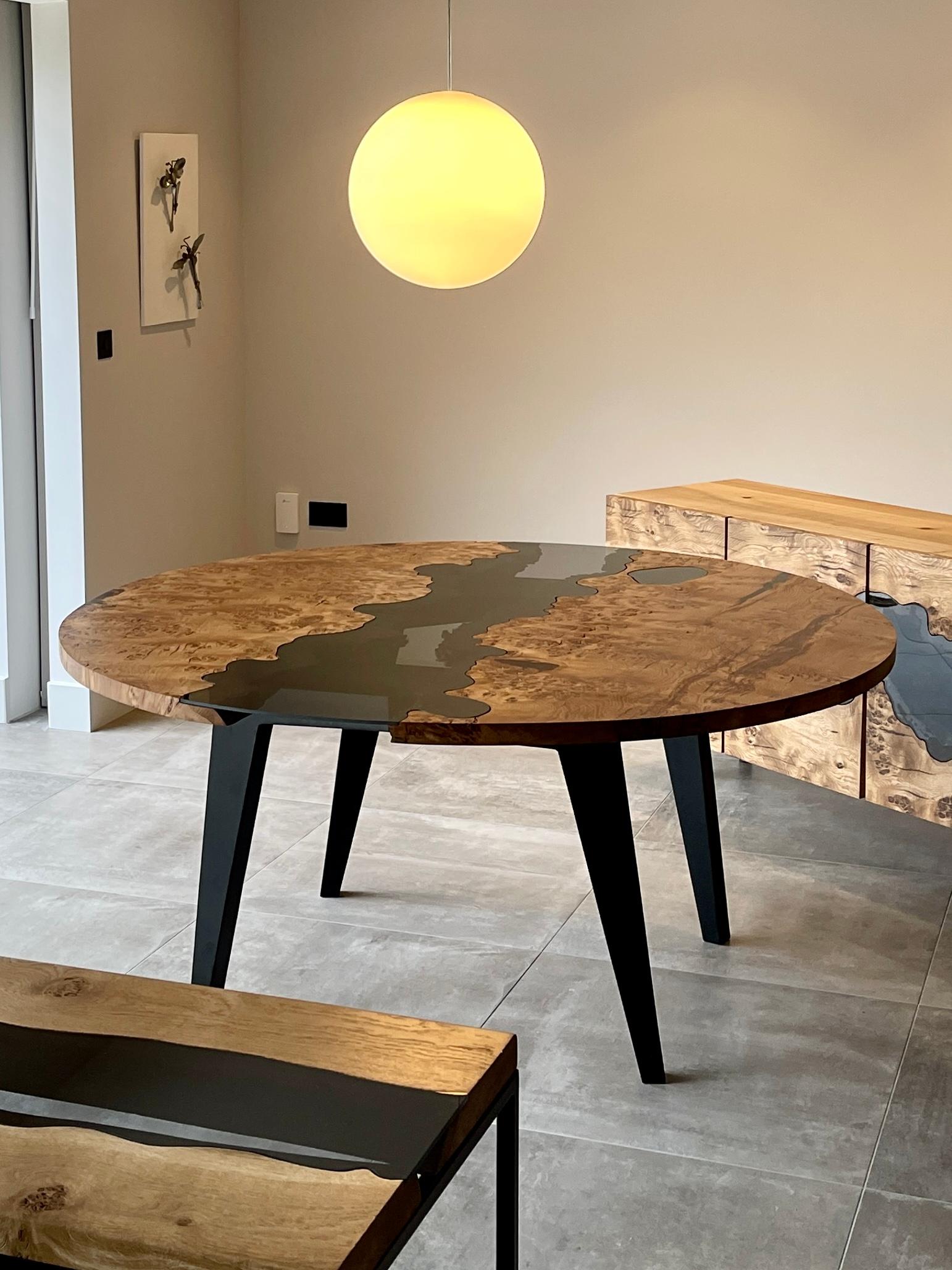 Table de salle à manger circulaire fabriquée à partir d'une sous-espèce rare de chêne, le chêne pippy anglais.
Le chêne est coupé en deux demi-cercles avec un vide au milieu - le vide est modelé selon chaque courbe et chaque mouvement de l'arête